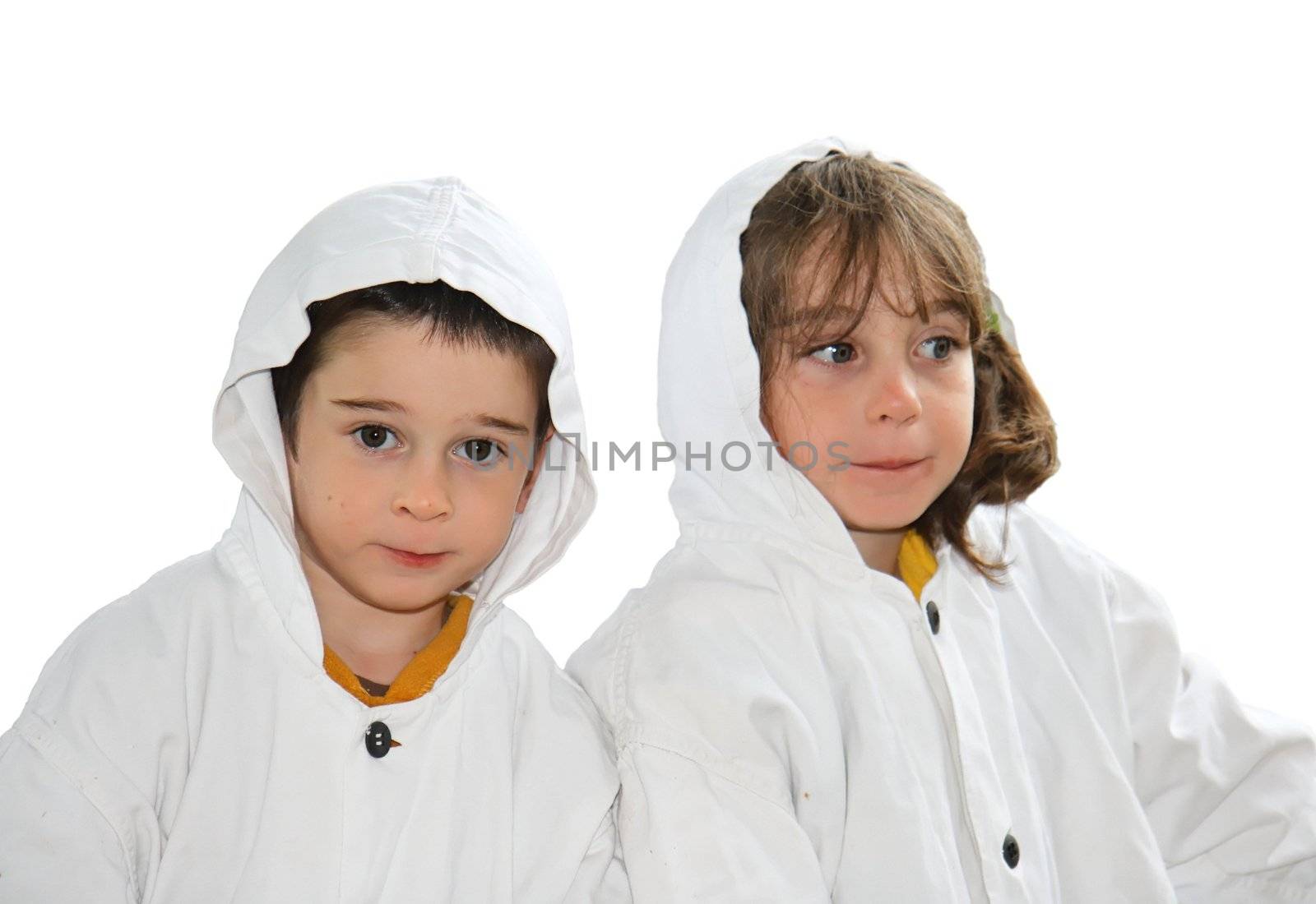 Cute preschool boy and girl in white hooded cloaks isolated