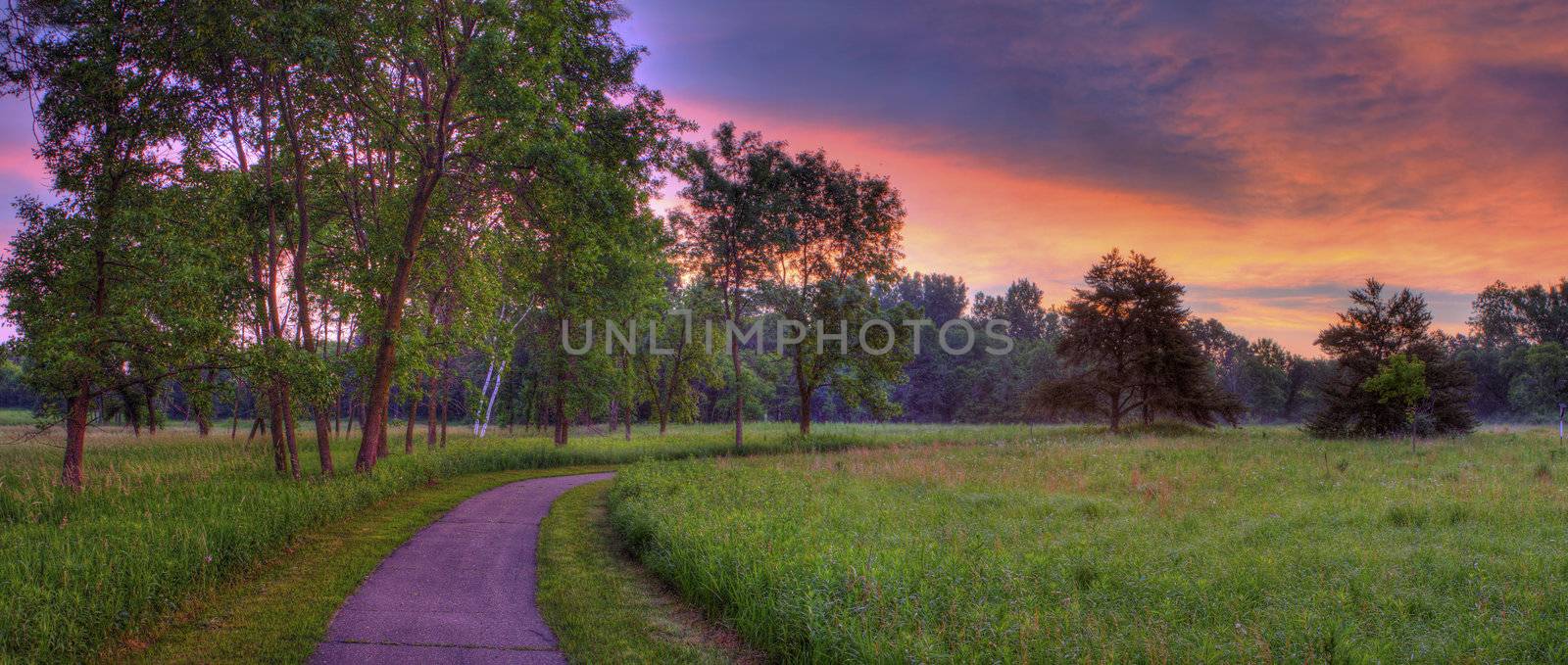 Beautiful sunrise on a walking path in the park.