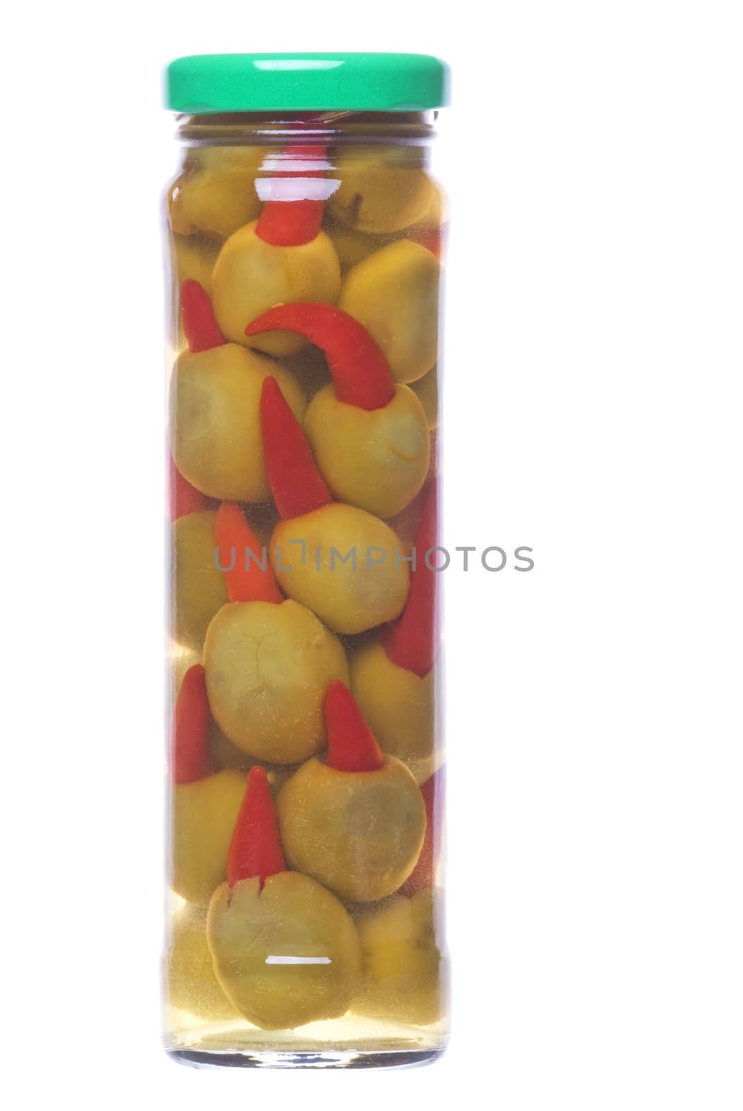 Isolated macro image of pickled pepper olives in a bottle.