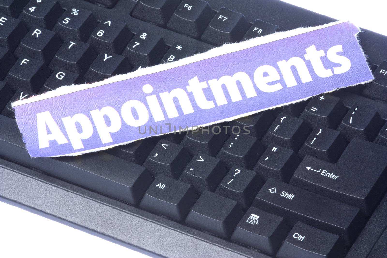 Image of a newspaper cutting with the words Appointment placed on a computer keyboard.