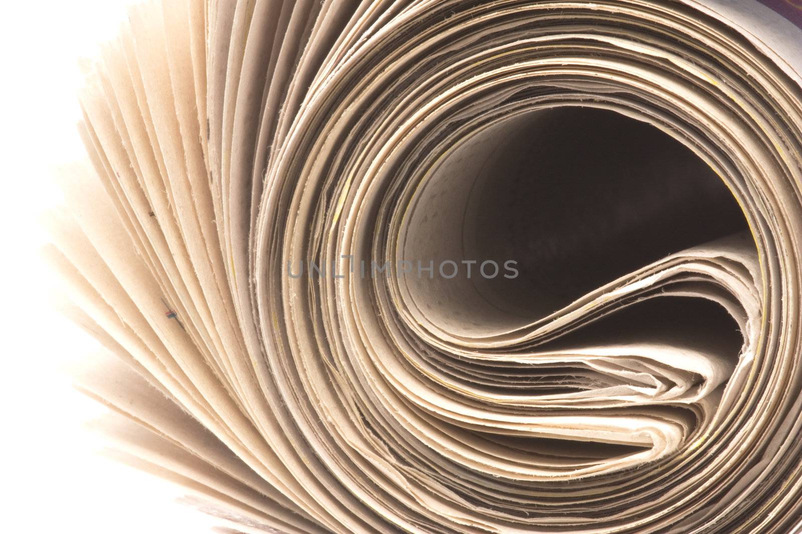 Isolated macro image of a roll of newspaper.