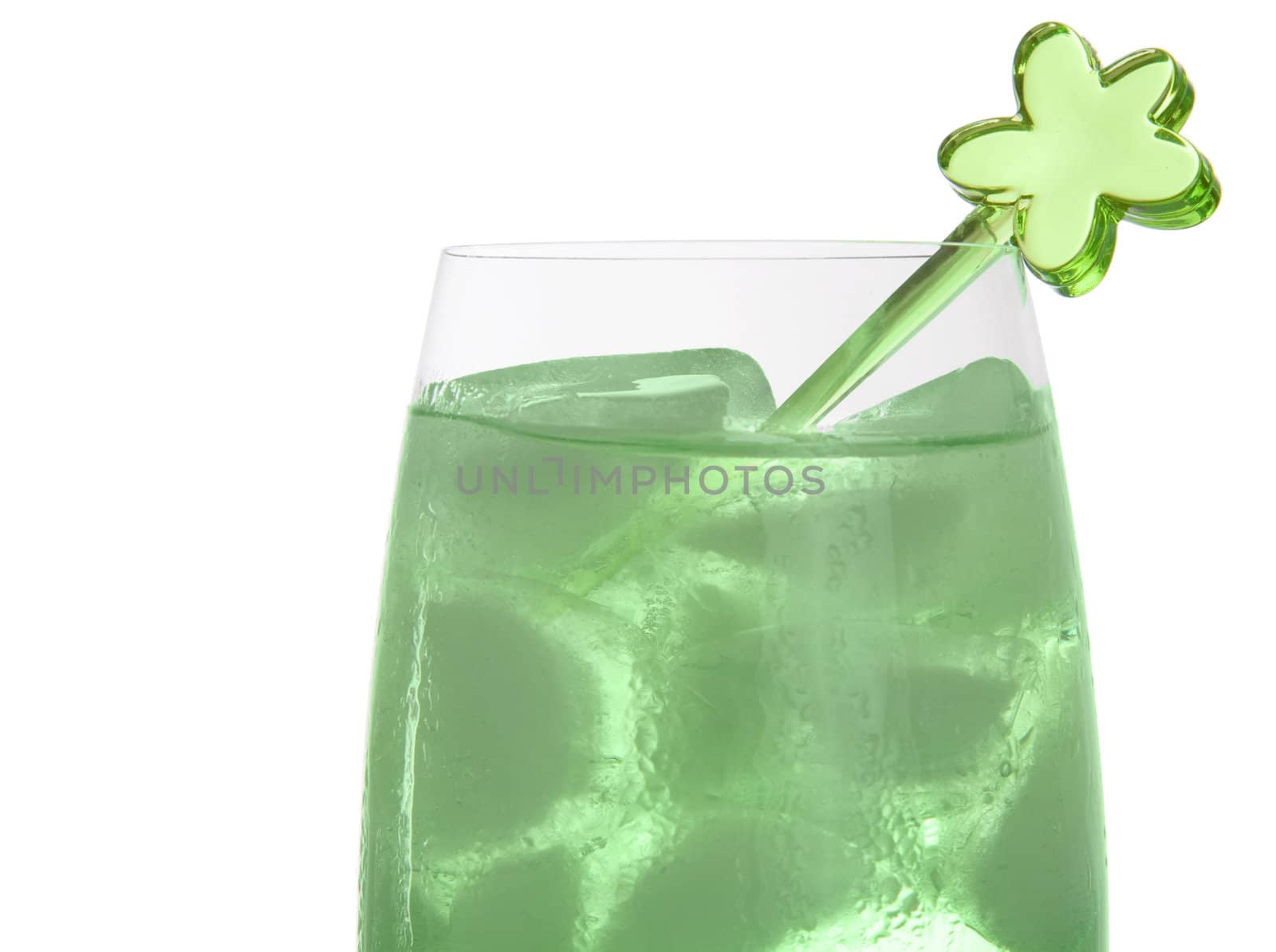 Bright green drink in a tall champagne glass with a green plastic decoration