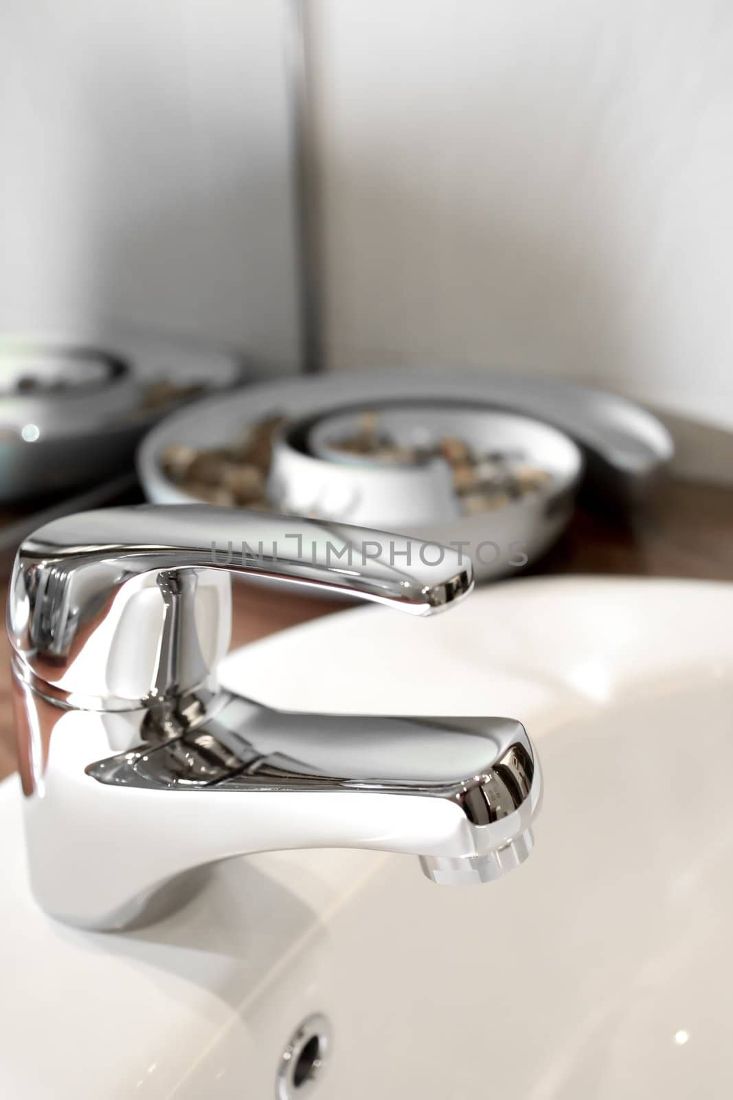 tap of a clean washbasin with ornament on the background
