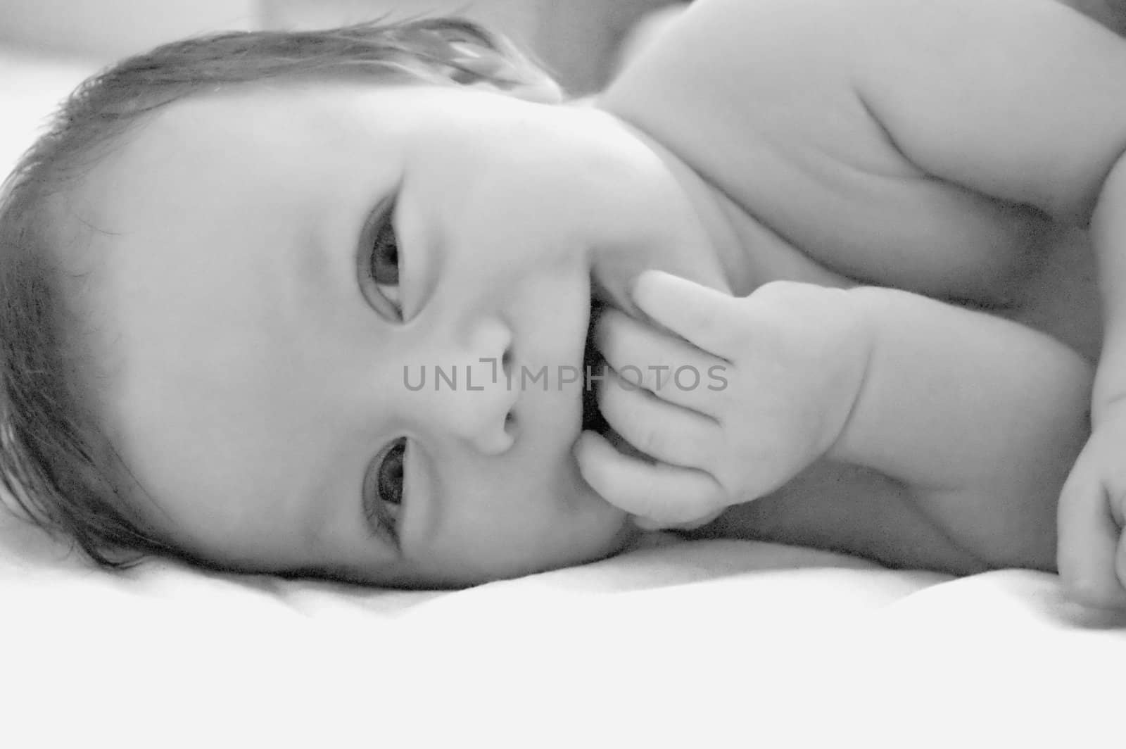Adorable baby boy laughing, black and white image