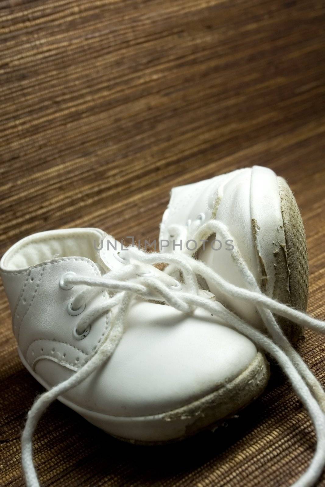worn and used white baby shoes