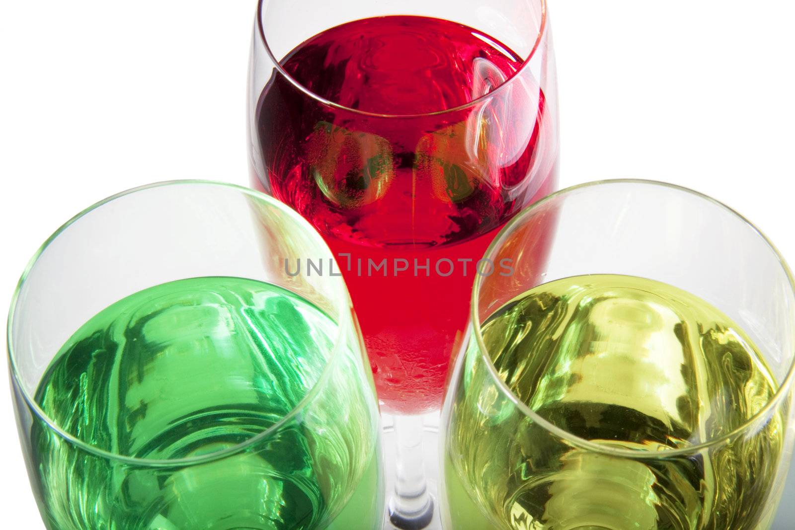 Three solorful cocktails for a party or celebration served in a champagne glass