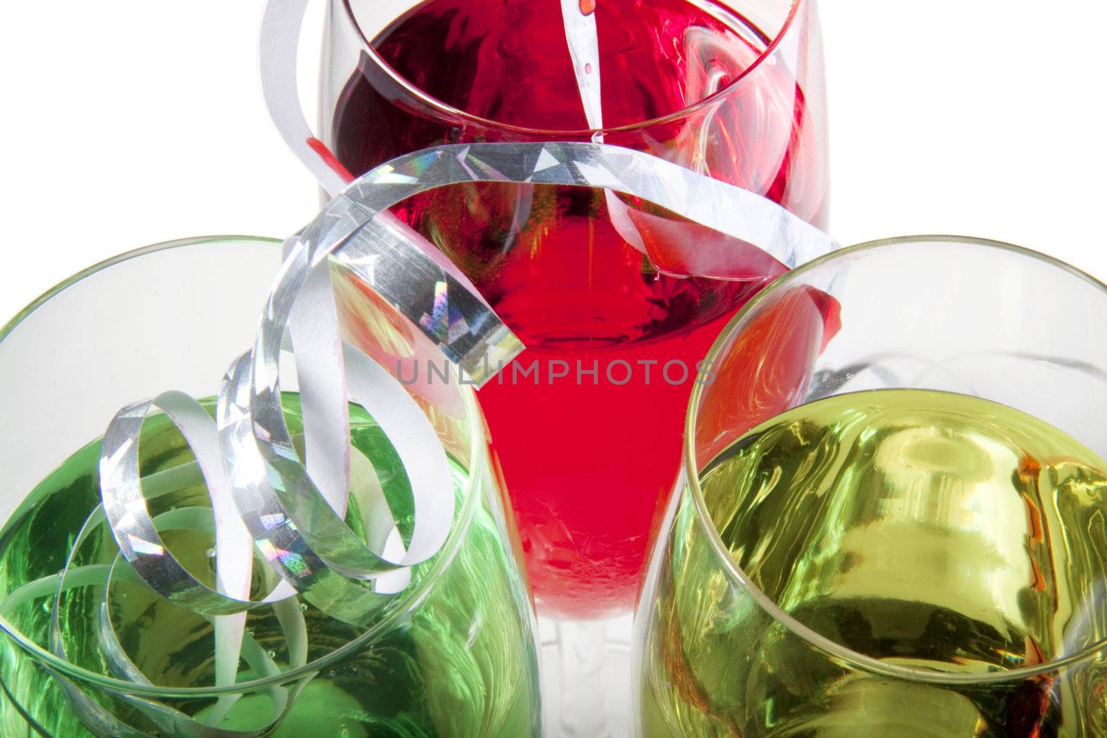 Three solorful cocktails for a party or celebration served in a champagne glass