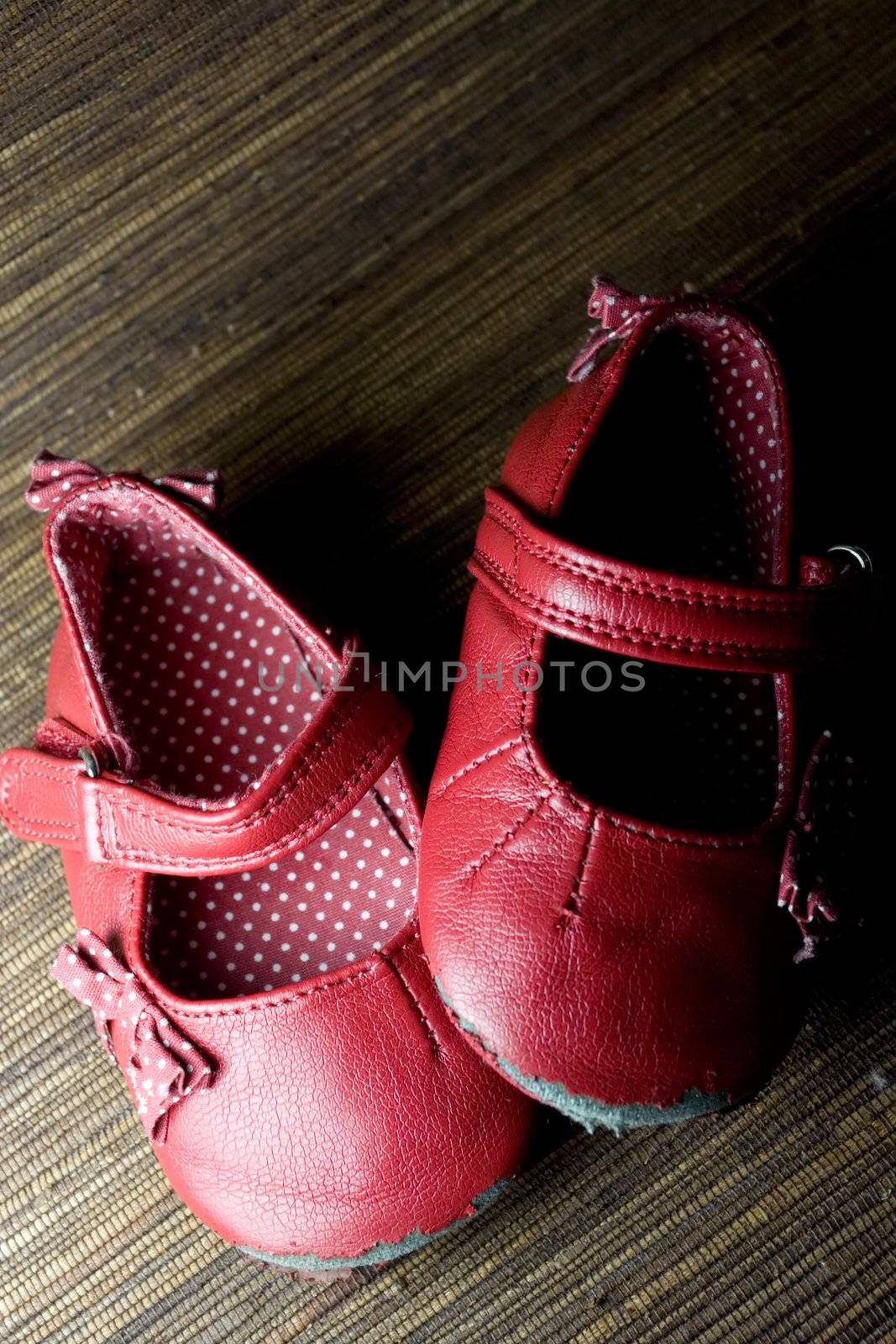 worn and used red baby girl shoes