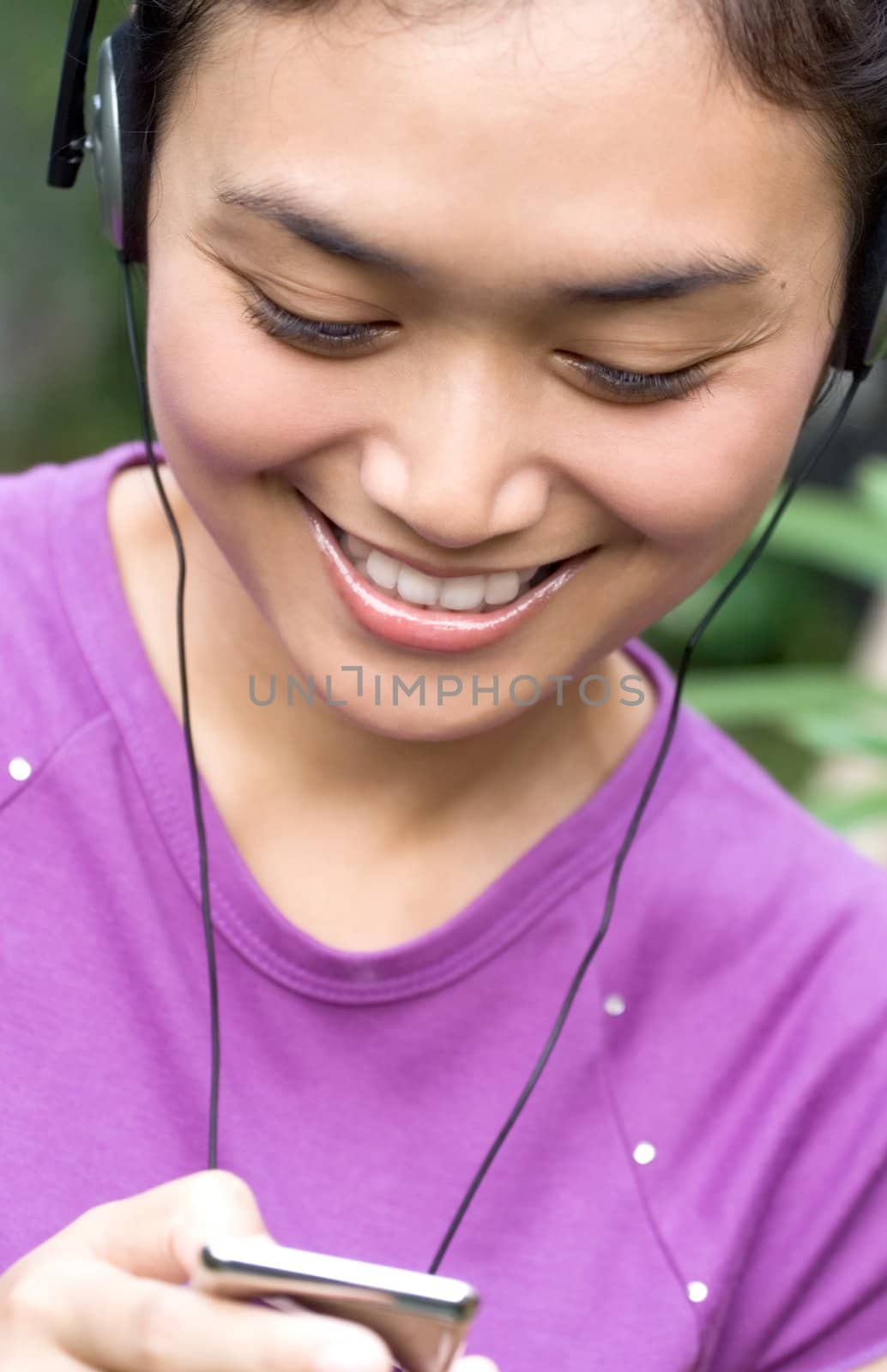 asian young woman with headphone listening music from mp3 player