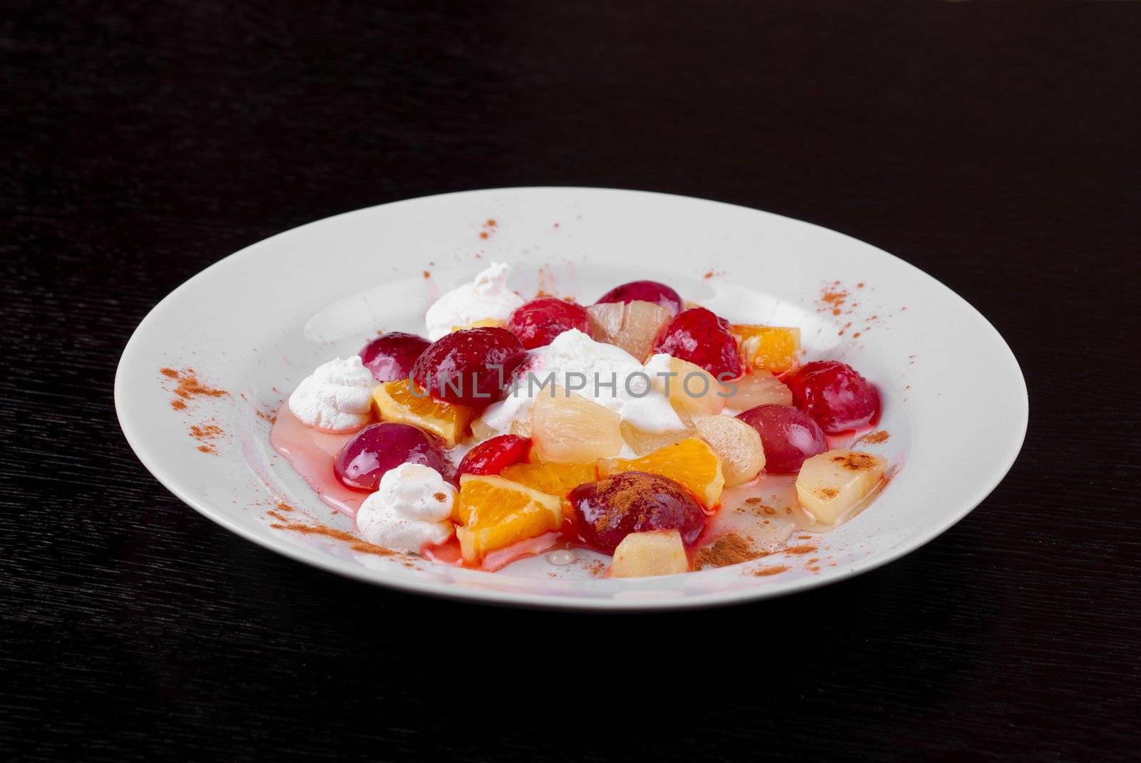 fruit salad of pineapple, grape, orange and strawberry with whipped cream