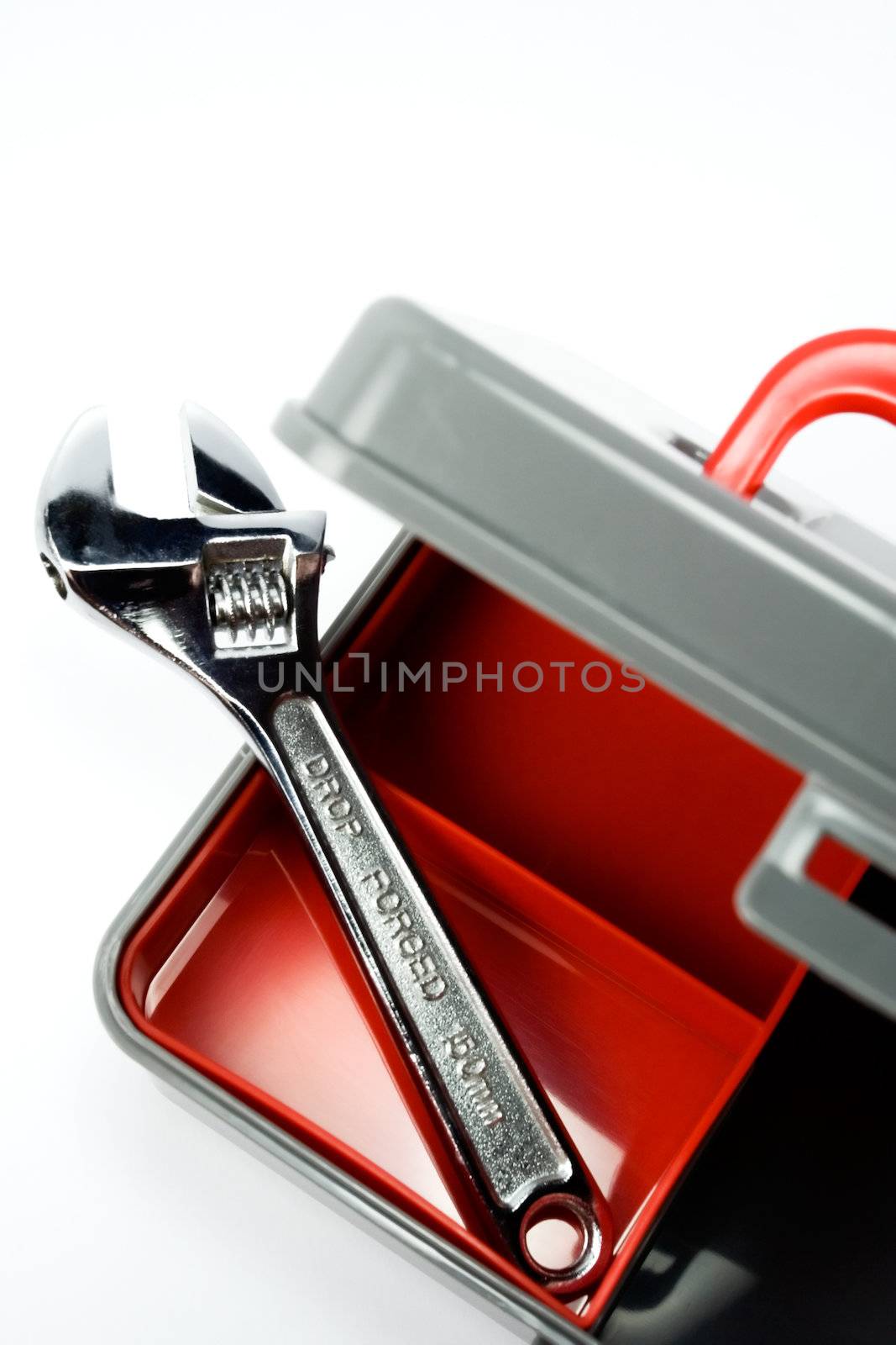 clean plastic tool box and an adjustable wrench isolated on white
