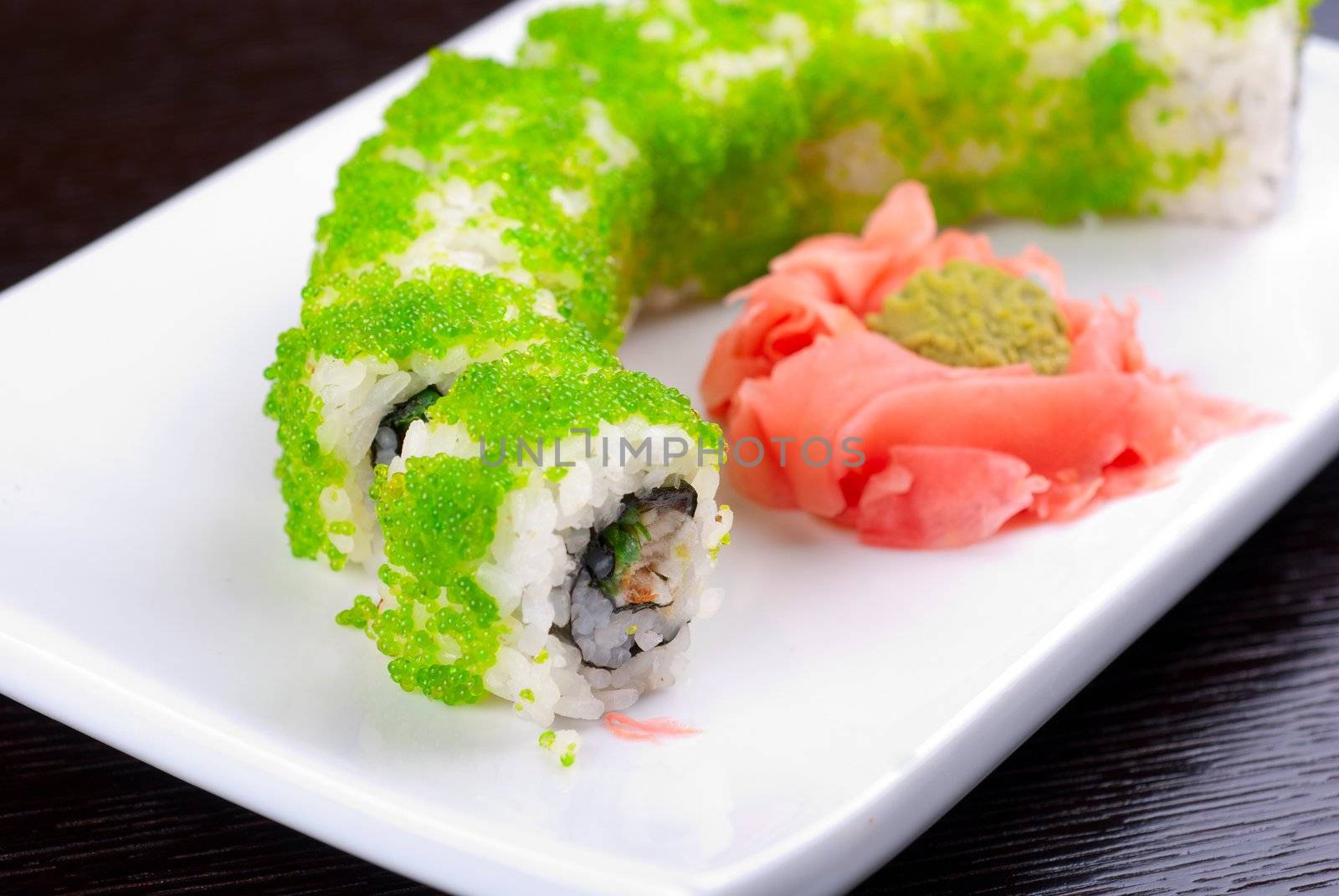 Sushi rolls made of salmon, avocado, flying fish roe - tobiko caviar and philadelphia cheese