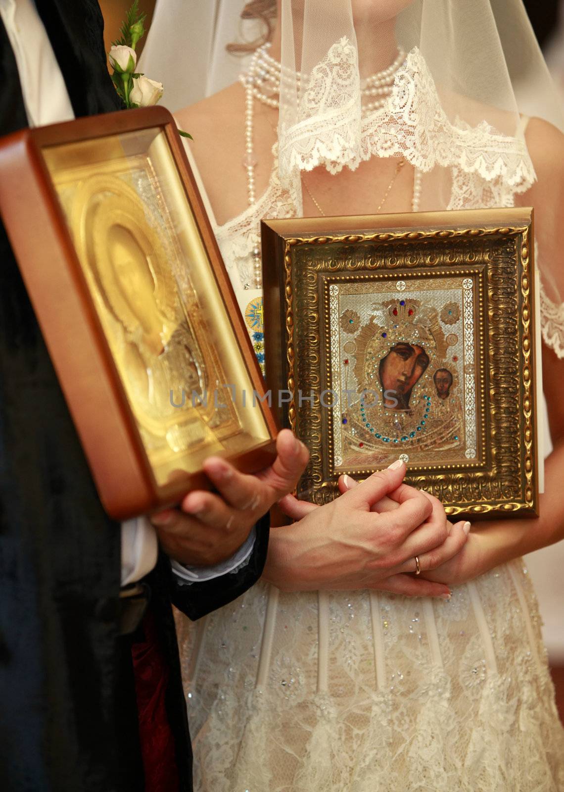 Newly-married couple on ceremony of wedding in church
