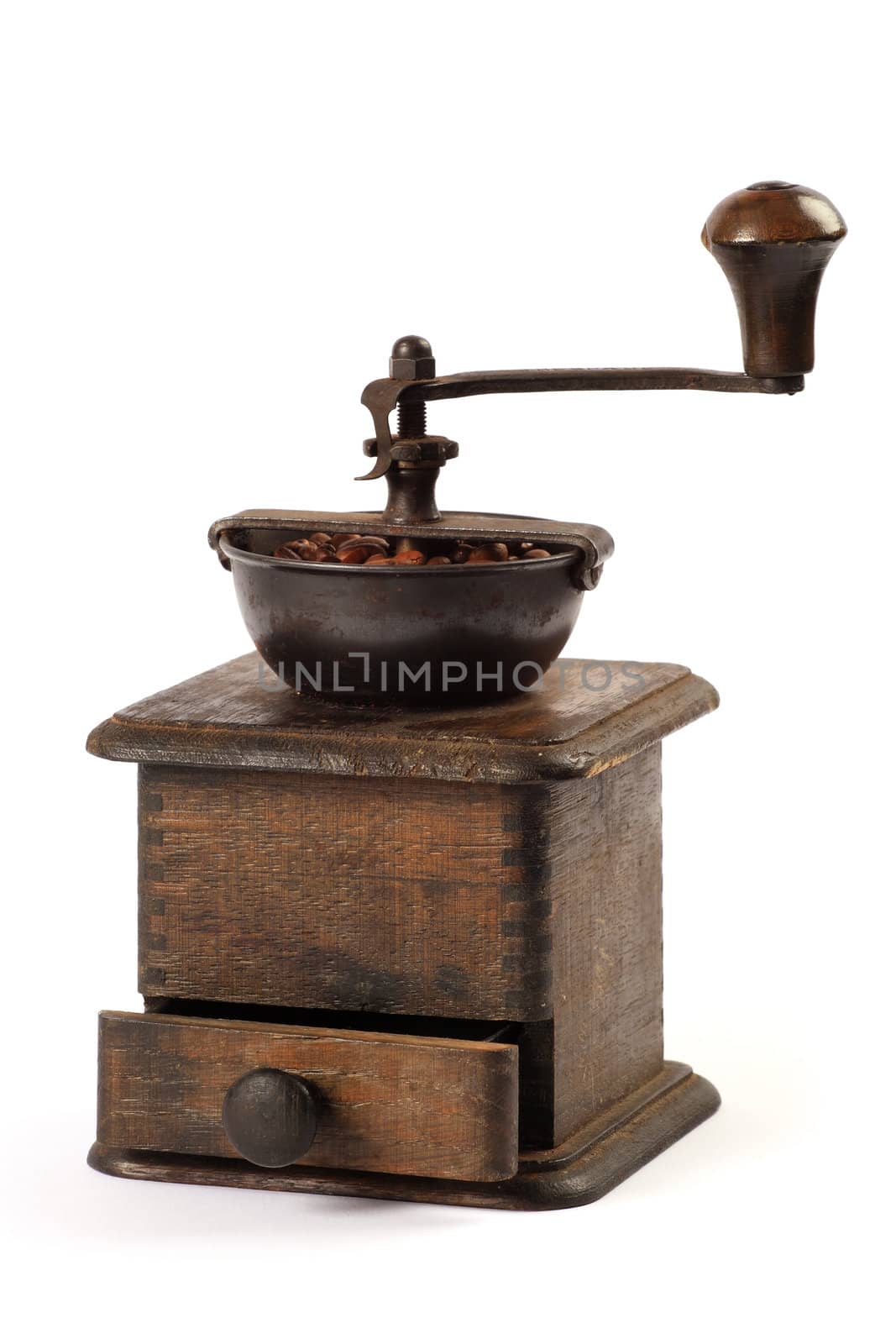 Photo of an antique coffee grinder isolated on a white background.