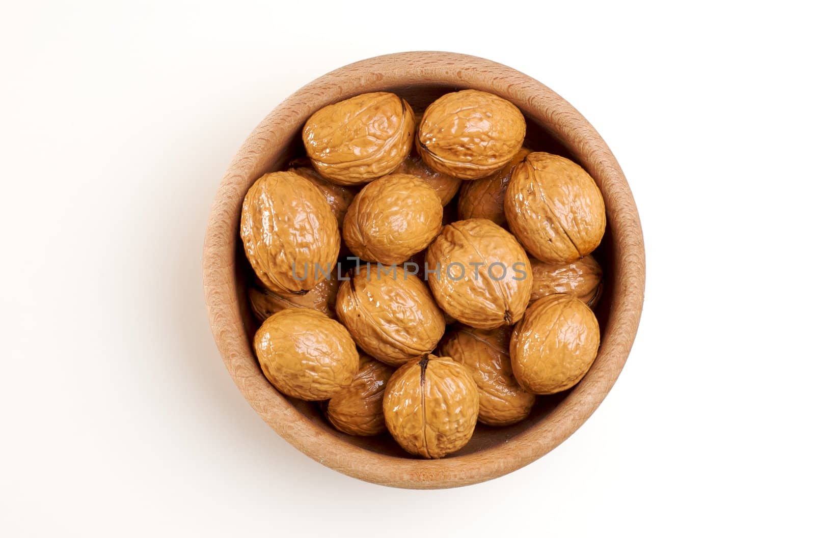 Bowl of walnuts isolated on white