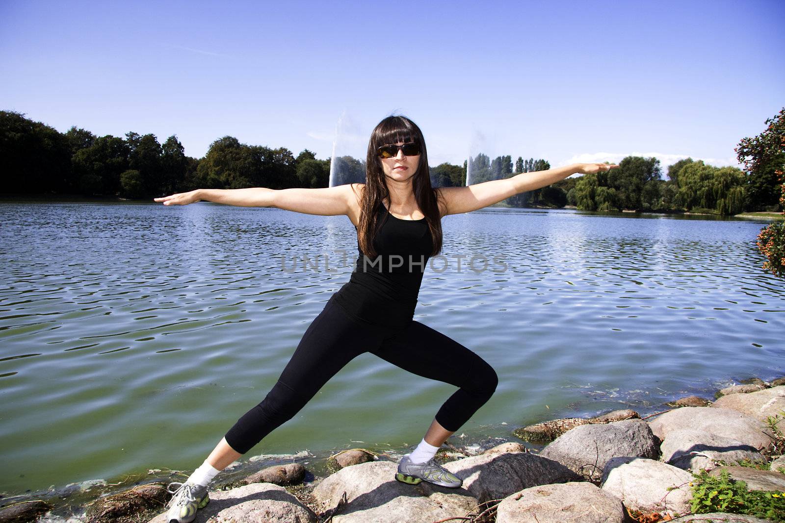 Woman doing a full stretch by kaferphoto