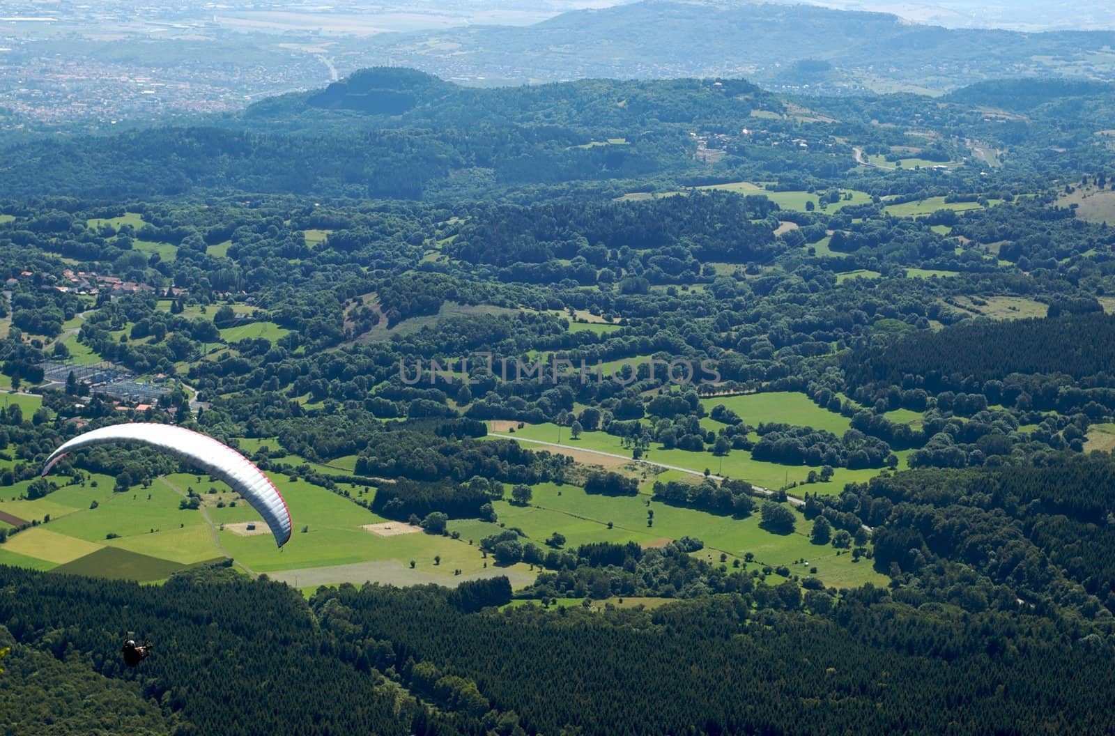 Paragliders floating above the hill of Puy de Dome in France