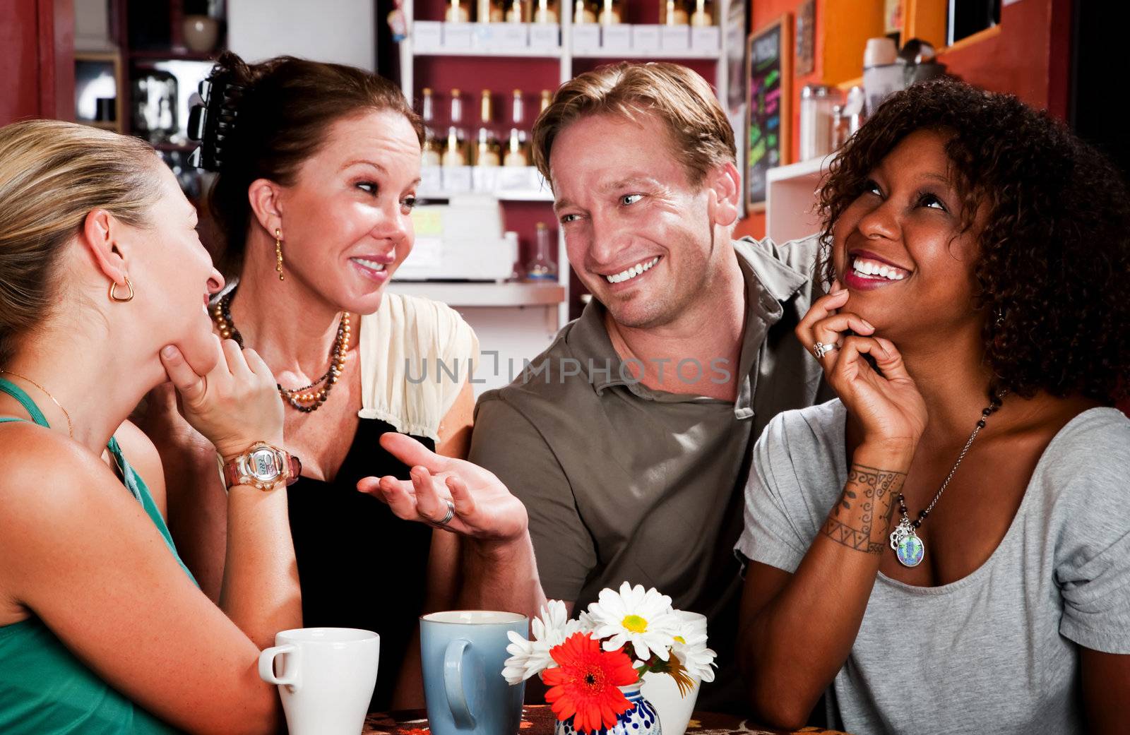 Man with three pretty women in coffee house by Creatista