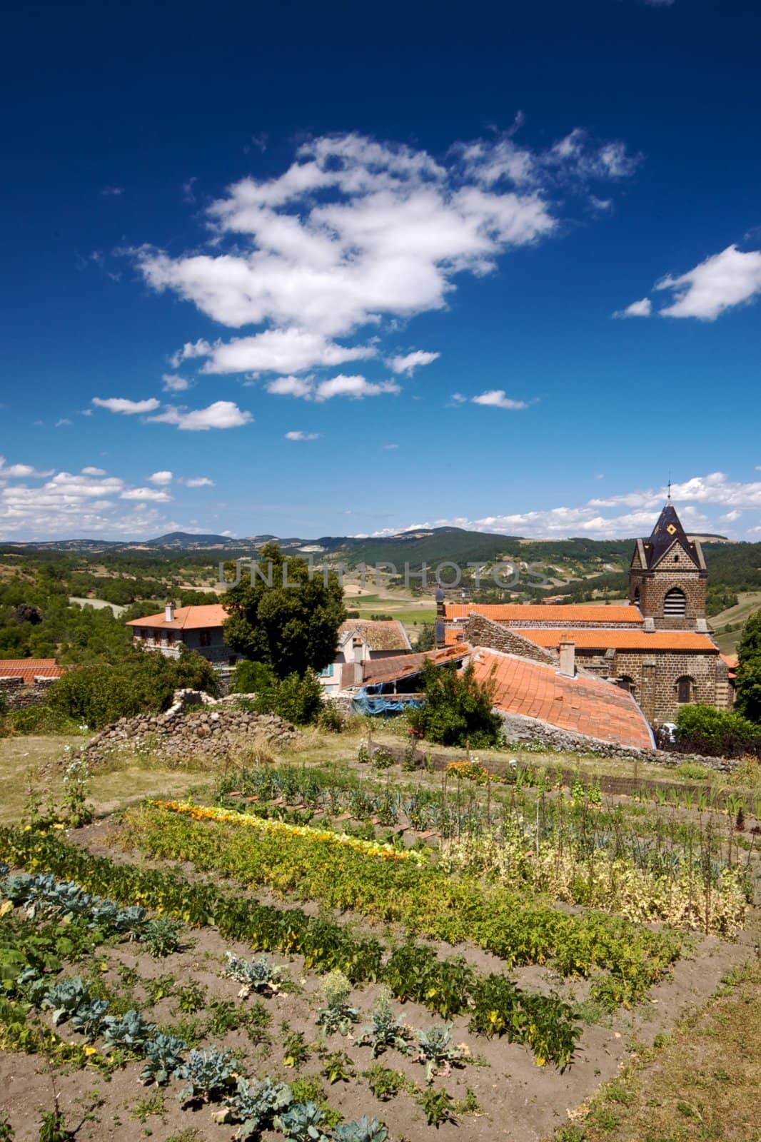 Wiejski ogrodek przy koscieleView from a hill on French countryside in summer