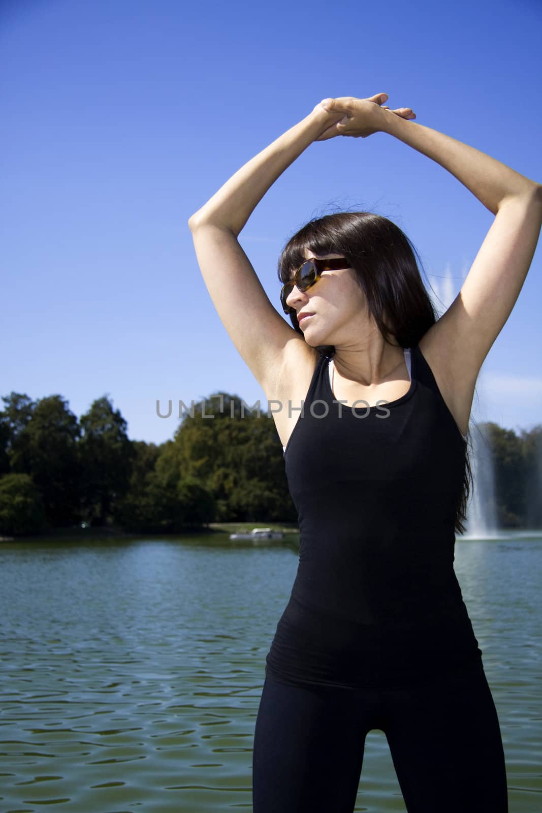 Latina is working out in the park stretching before a run