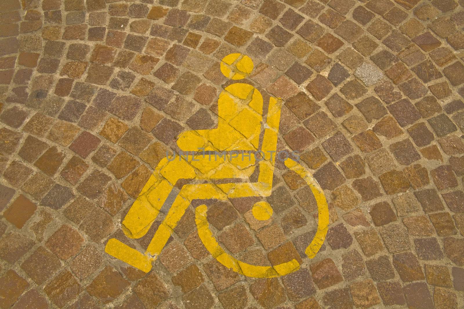 Yellow symbol for loading/unloading parking. handicapped parking symbol on the street floor.