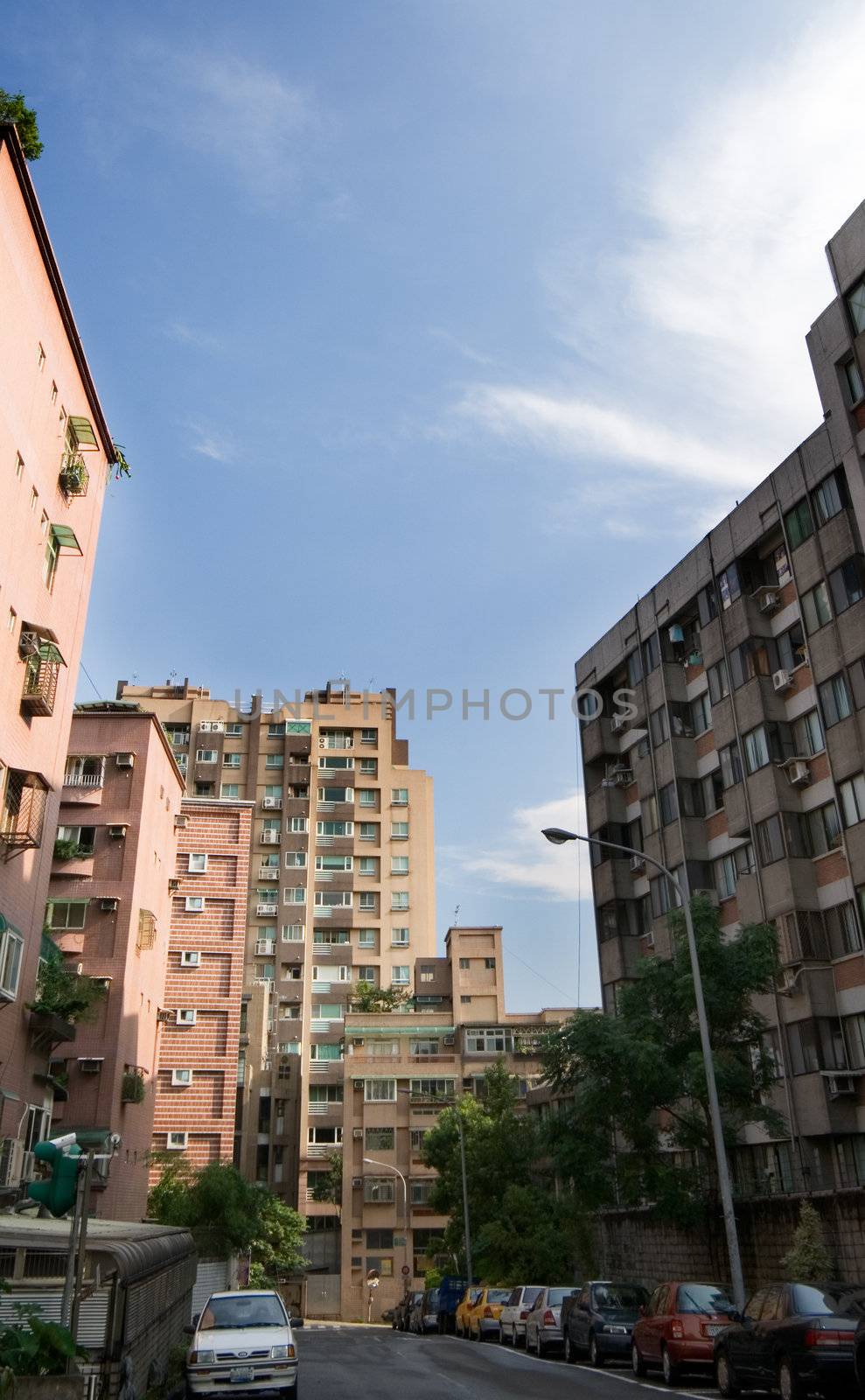 It is the cityscape of street and apartment.