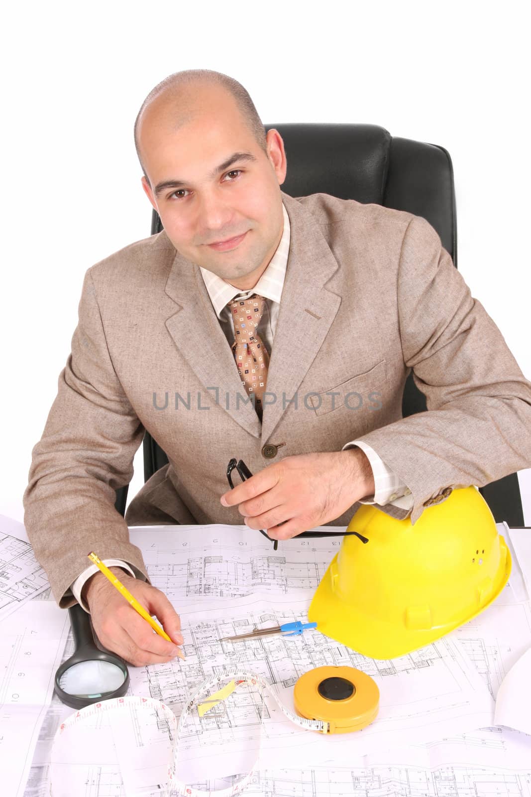 A businessman happiness with architectural plans at desk