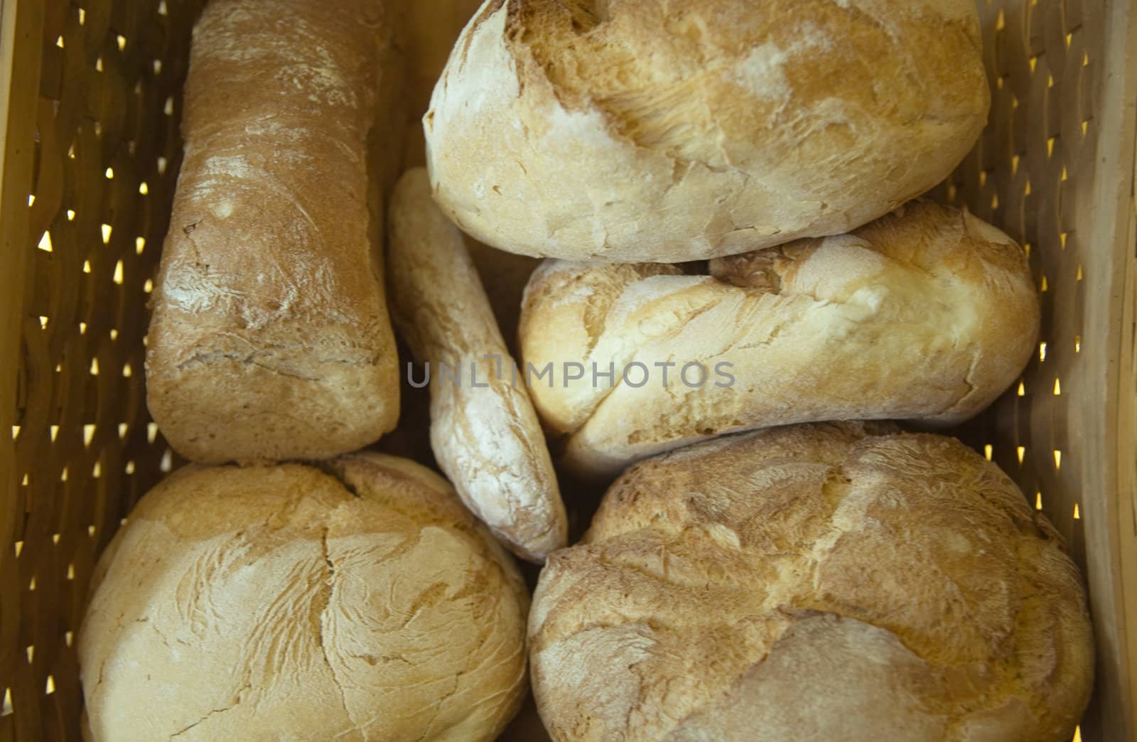 Six loafs of bread inside a basket.