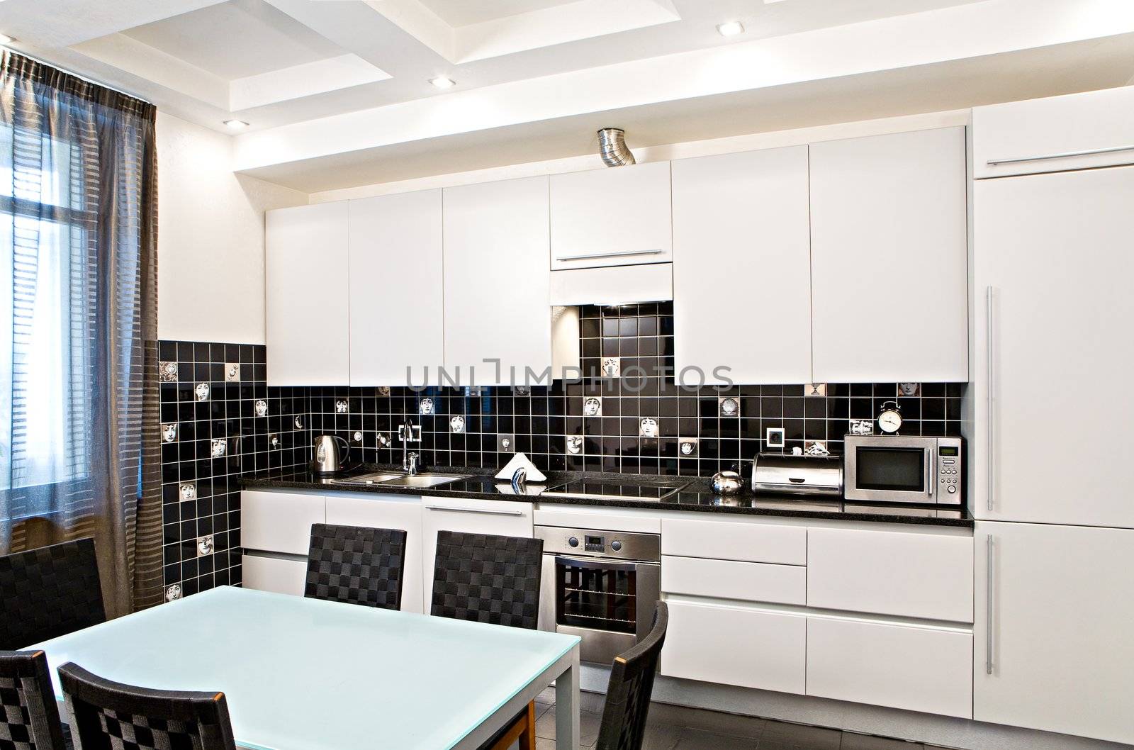 Interior of the modern kitchen with a table and chairs
