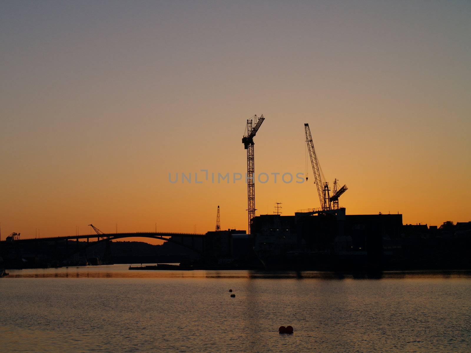harbour and cranes in sunset