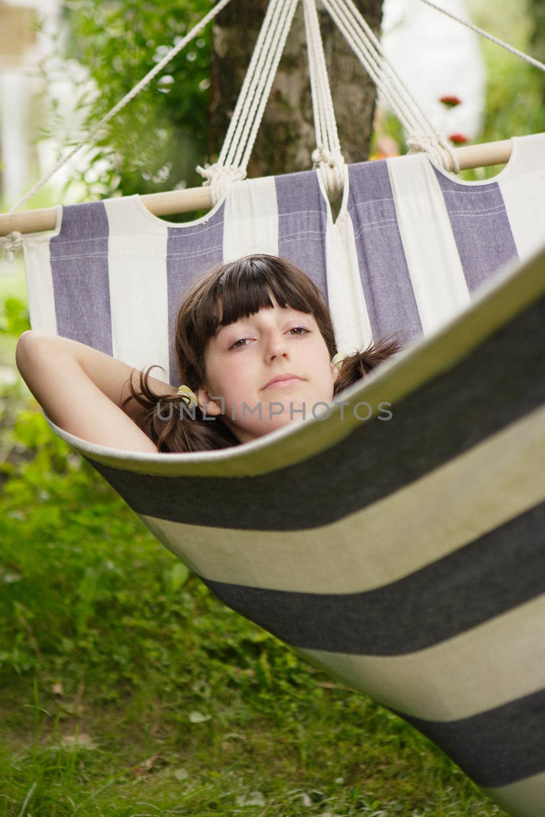 The girl lays in a hammock