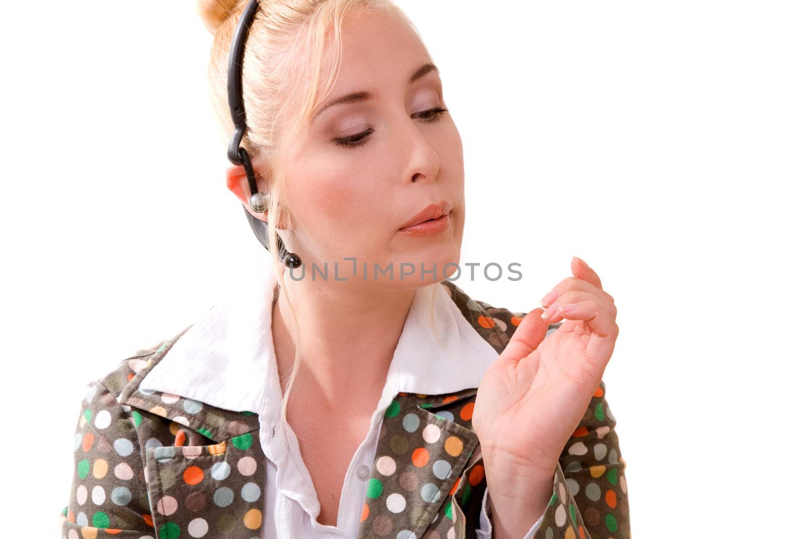 Pretty blond receptionist bored at the job blowing her nails