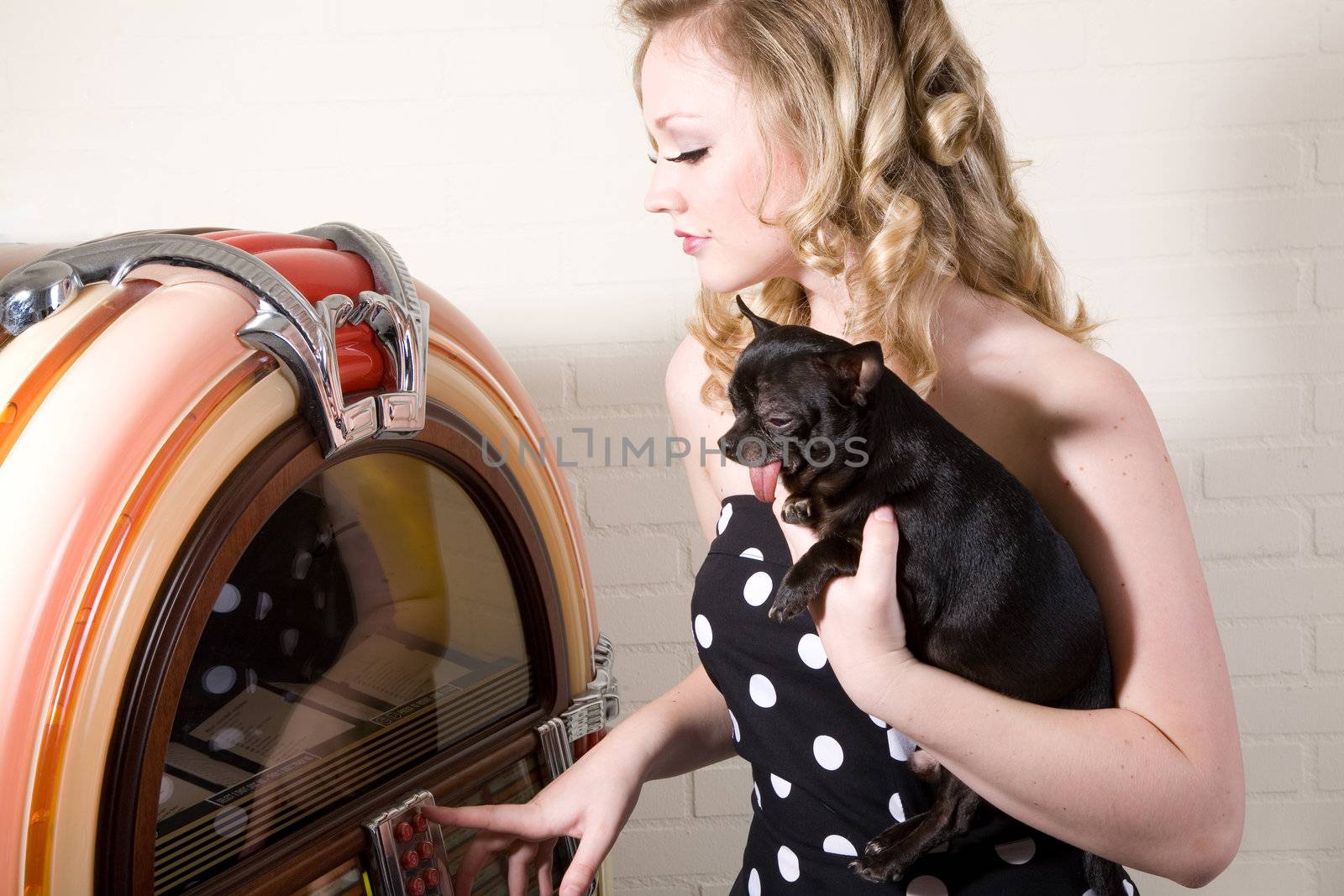 Pretty blond girl with chihuahua on her arm