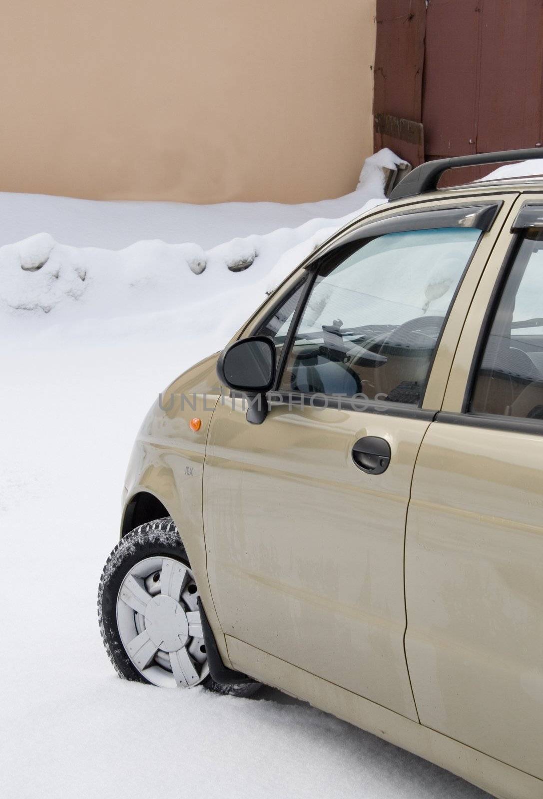 new car on white snow parked near a house
