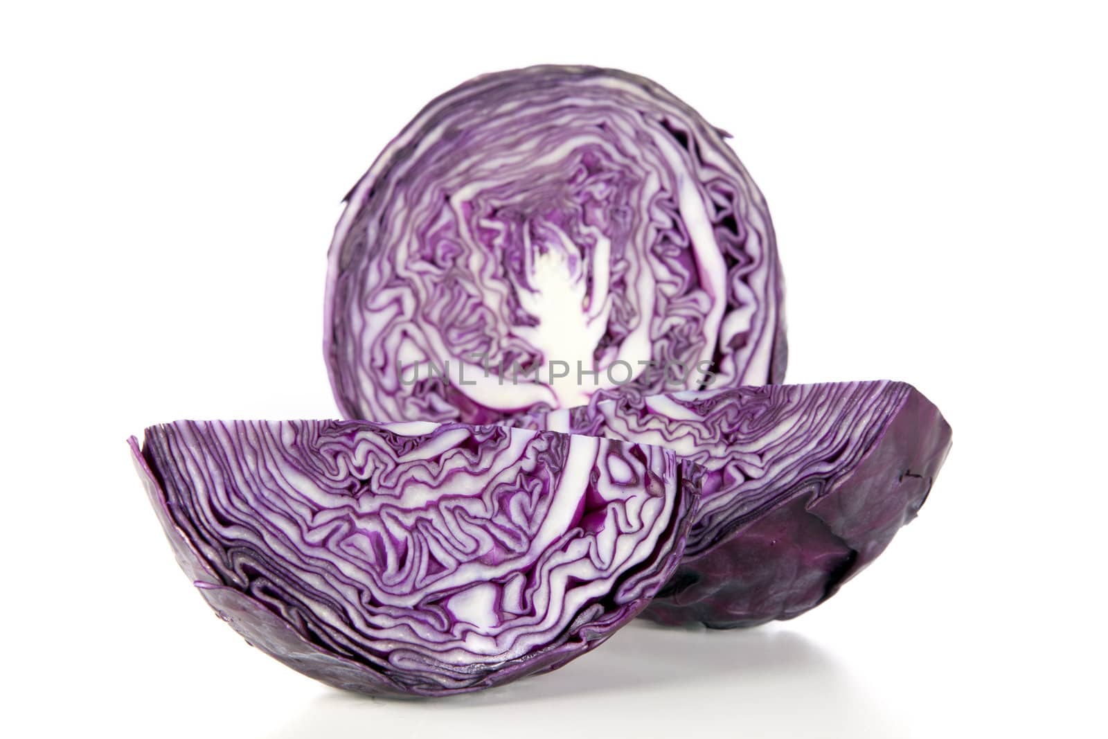 Raw purple cabbage cut into a half and two wedges.