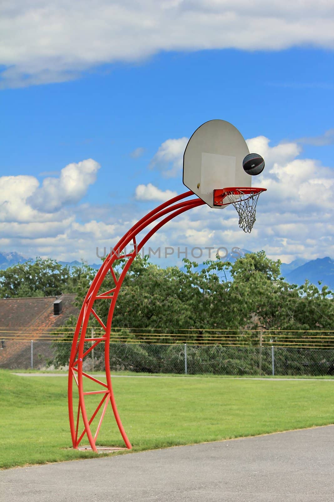 basketball hoop and sky and grass green