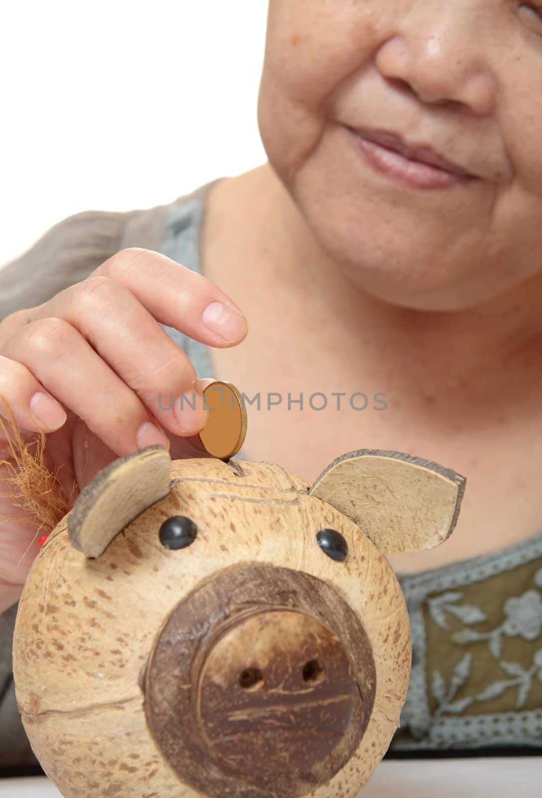 woman putting coins in small piggy bank. Selective focus, Copy space 