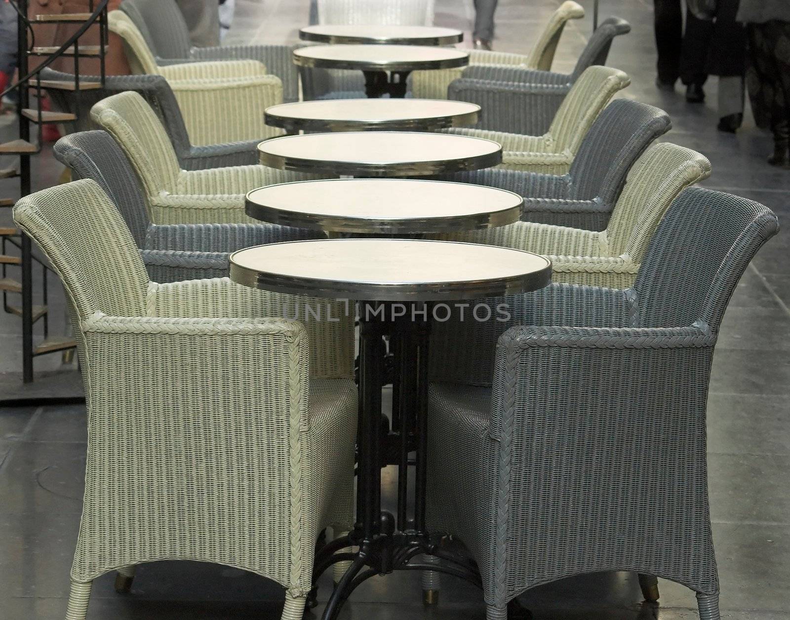 A row of coffee tables in a small cafe in the royal passage in Brussels