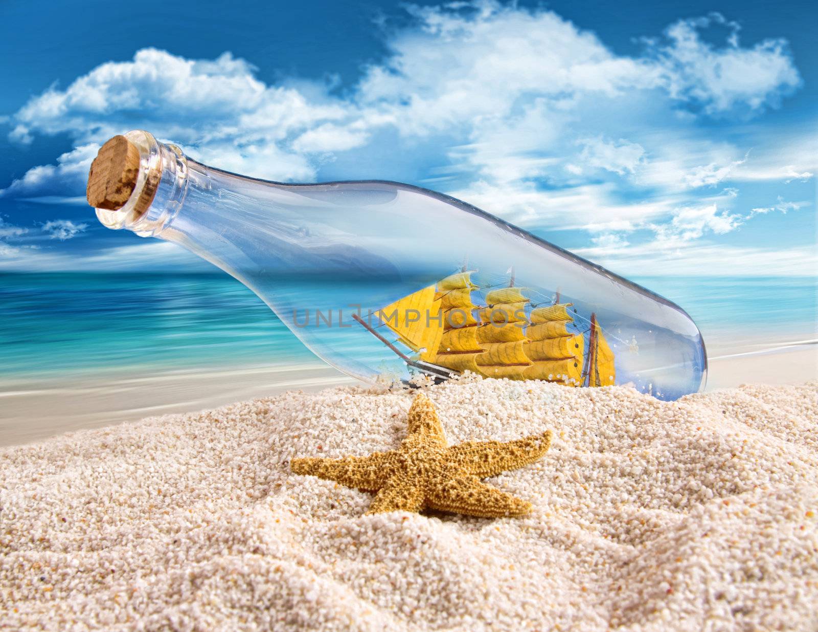 Ship in a bottle lying in the sand