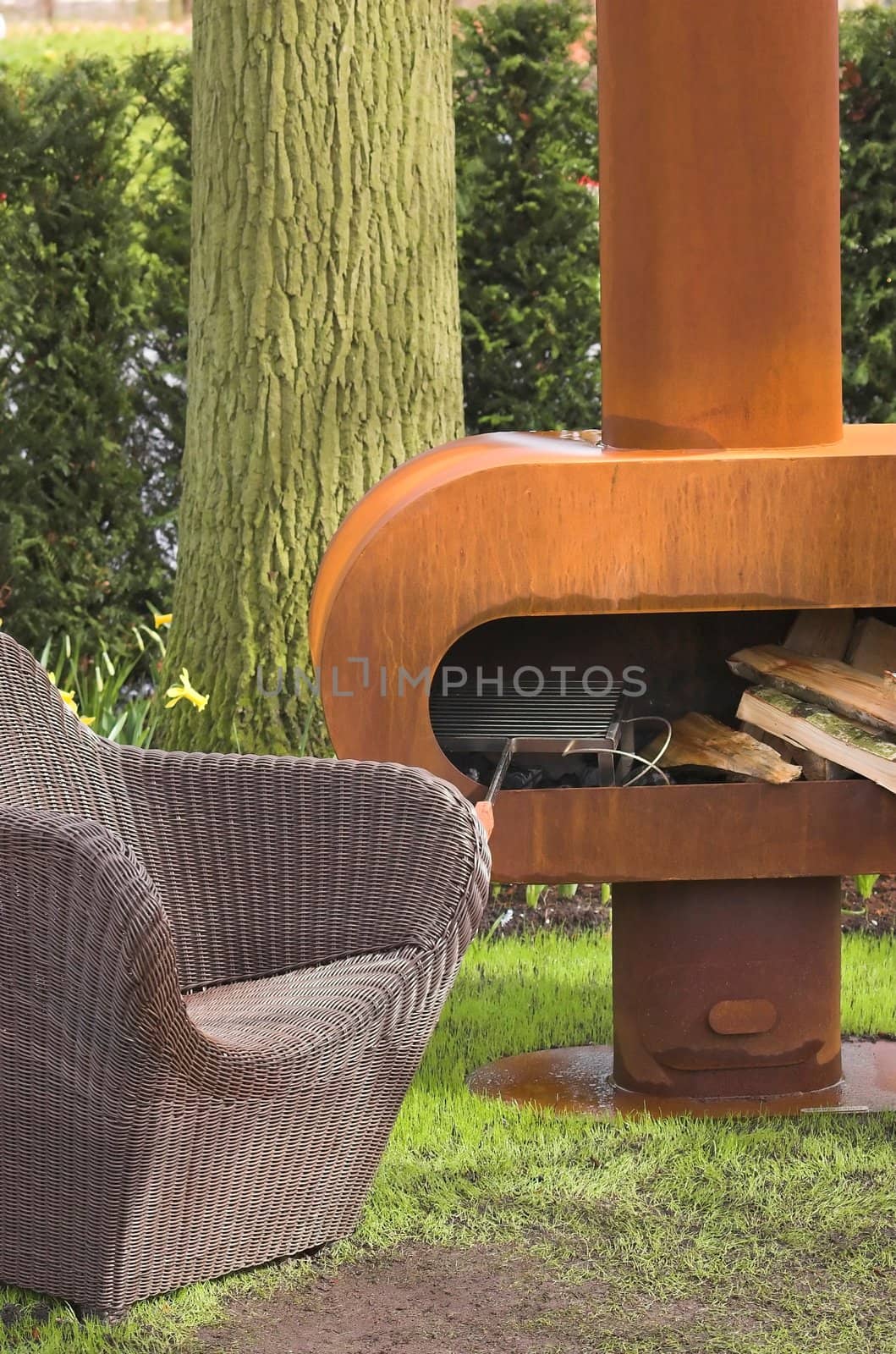 Modern barbecue with an armchair made of rattan