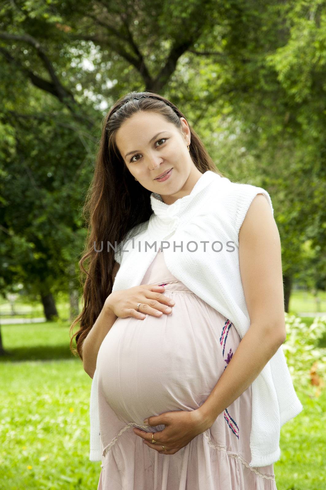 Pregnant Young Woman smile in summer park