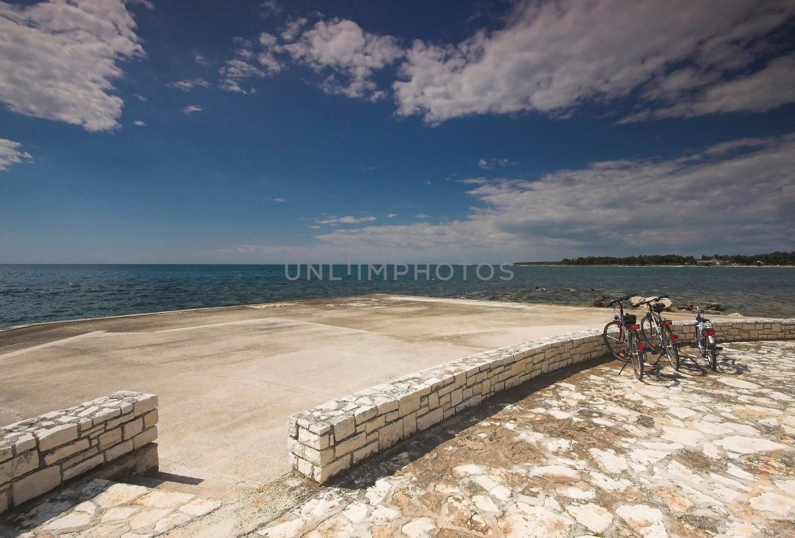 Three bicycles parked on a stony beach in Croatia