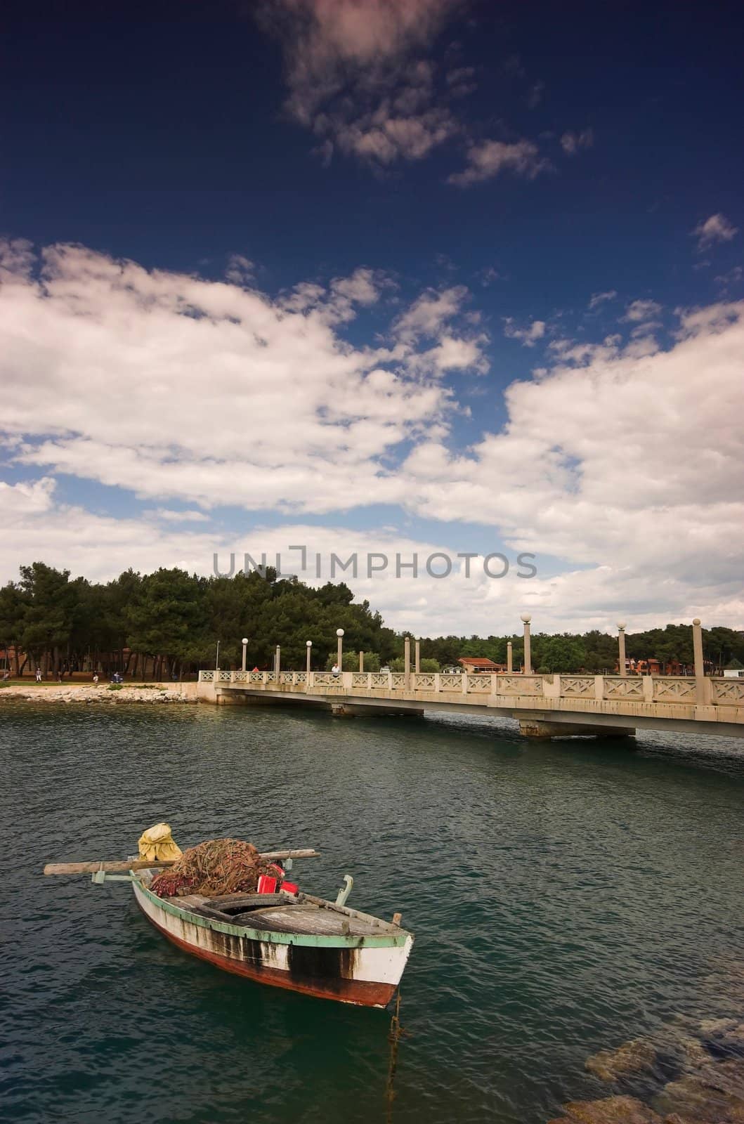 Fishing boat moored next to a bridge at the edge of Adriatic