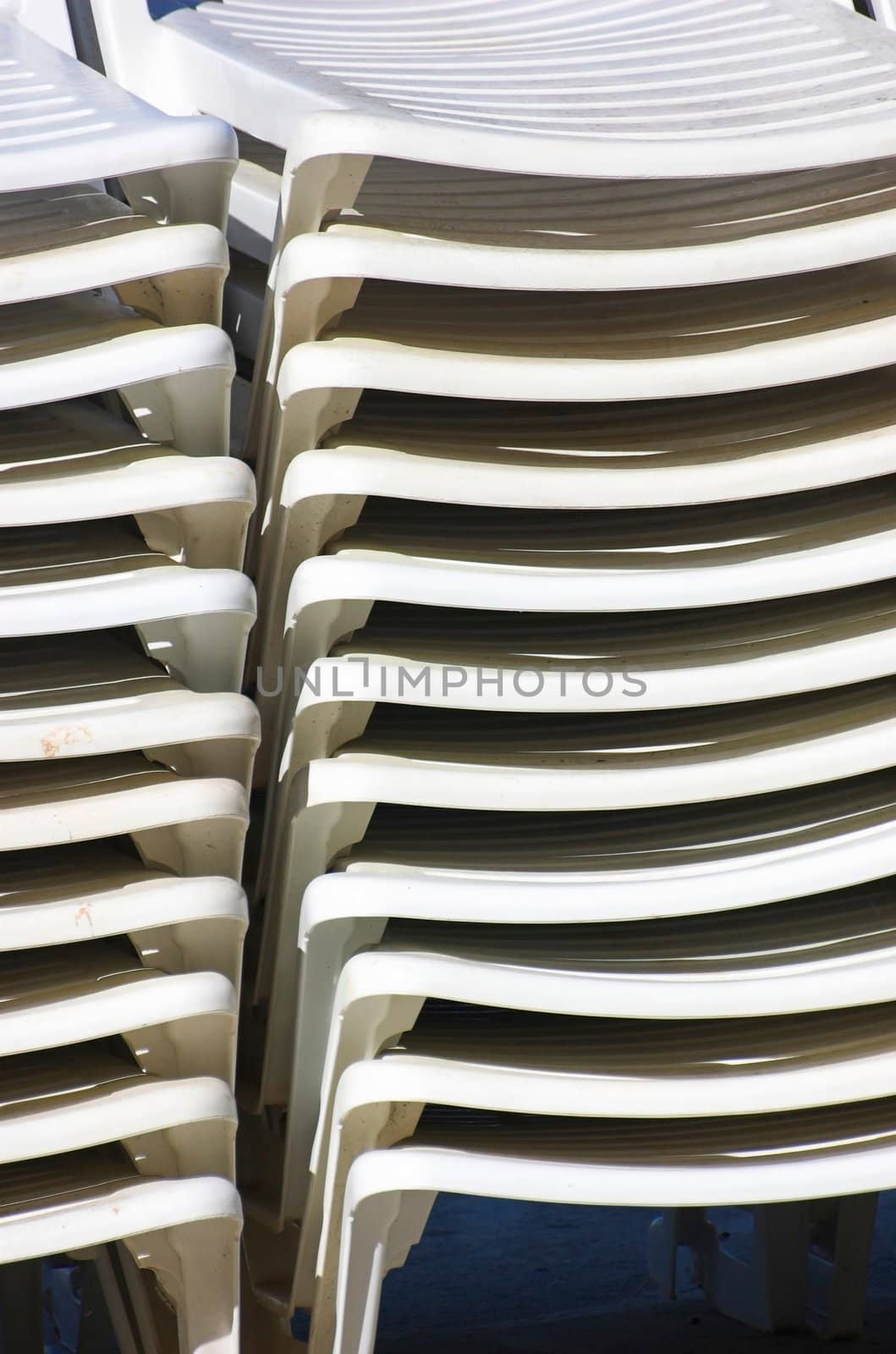 Plastic beach chairs stacked on top of each other