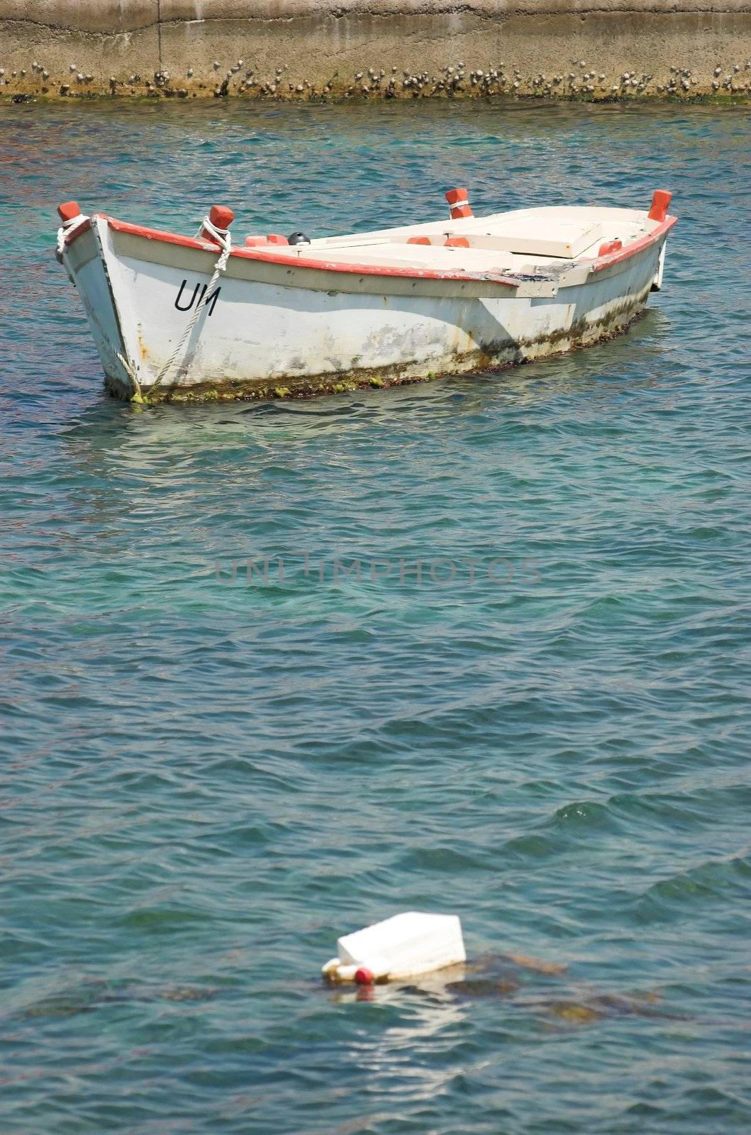 White fishing boat moored in an harbor