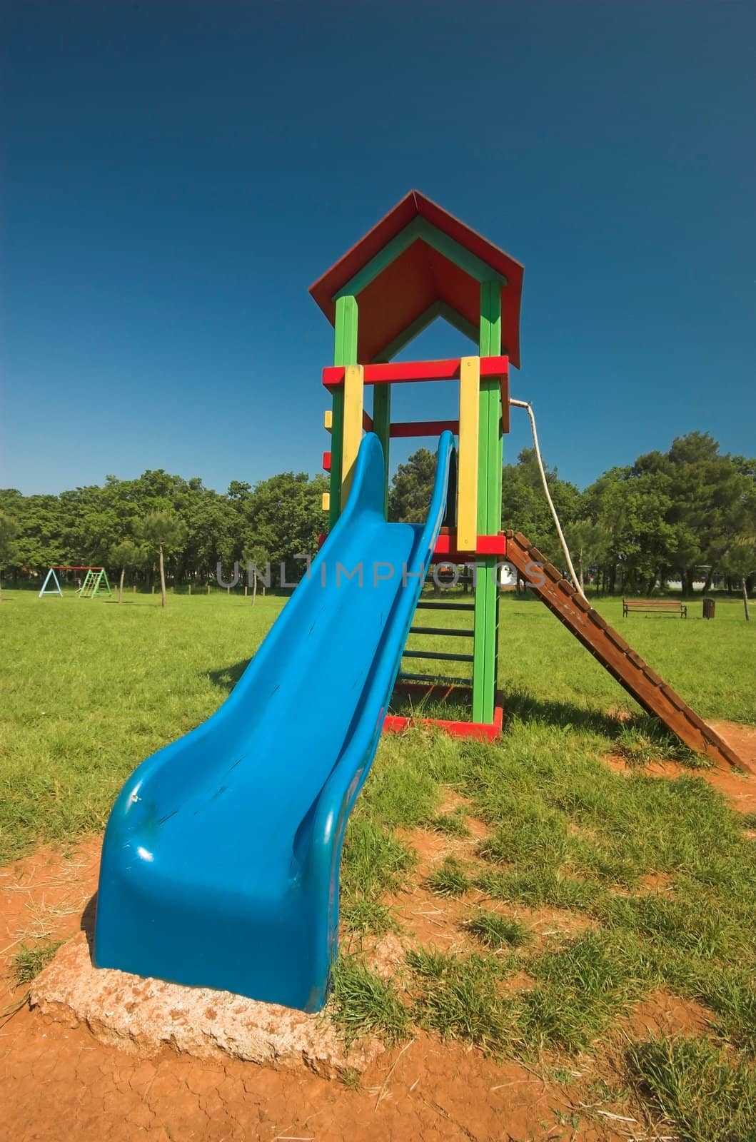 Blue slide at a children's playground in summer