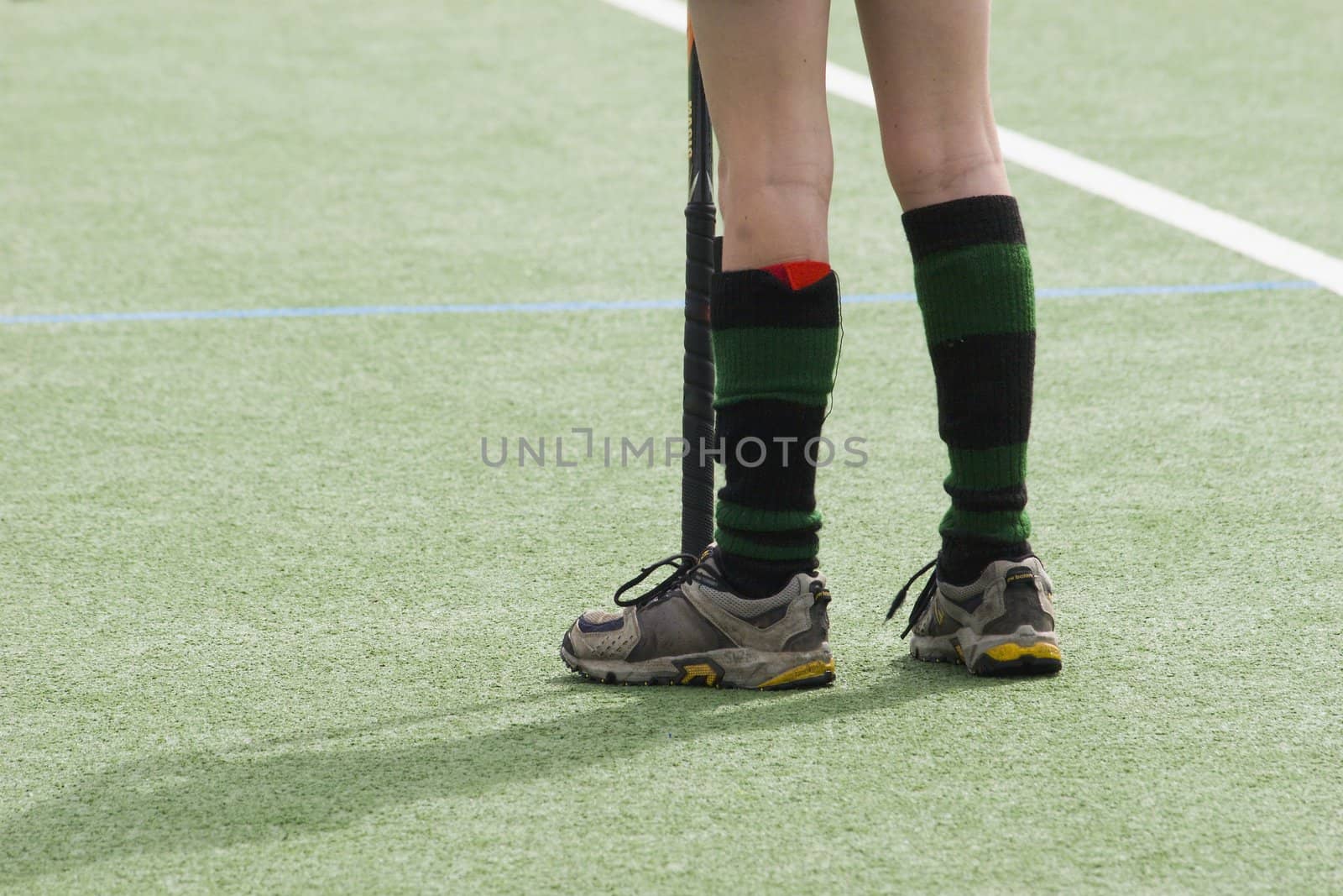 Kid standing on artificial turf playing hockey