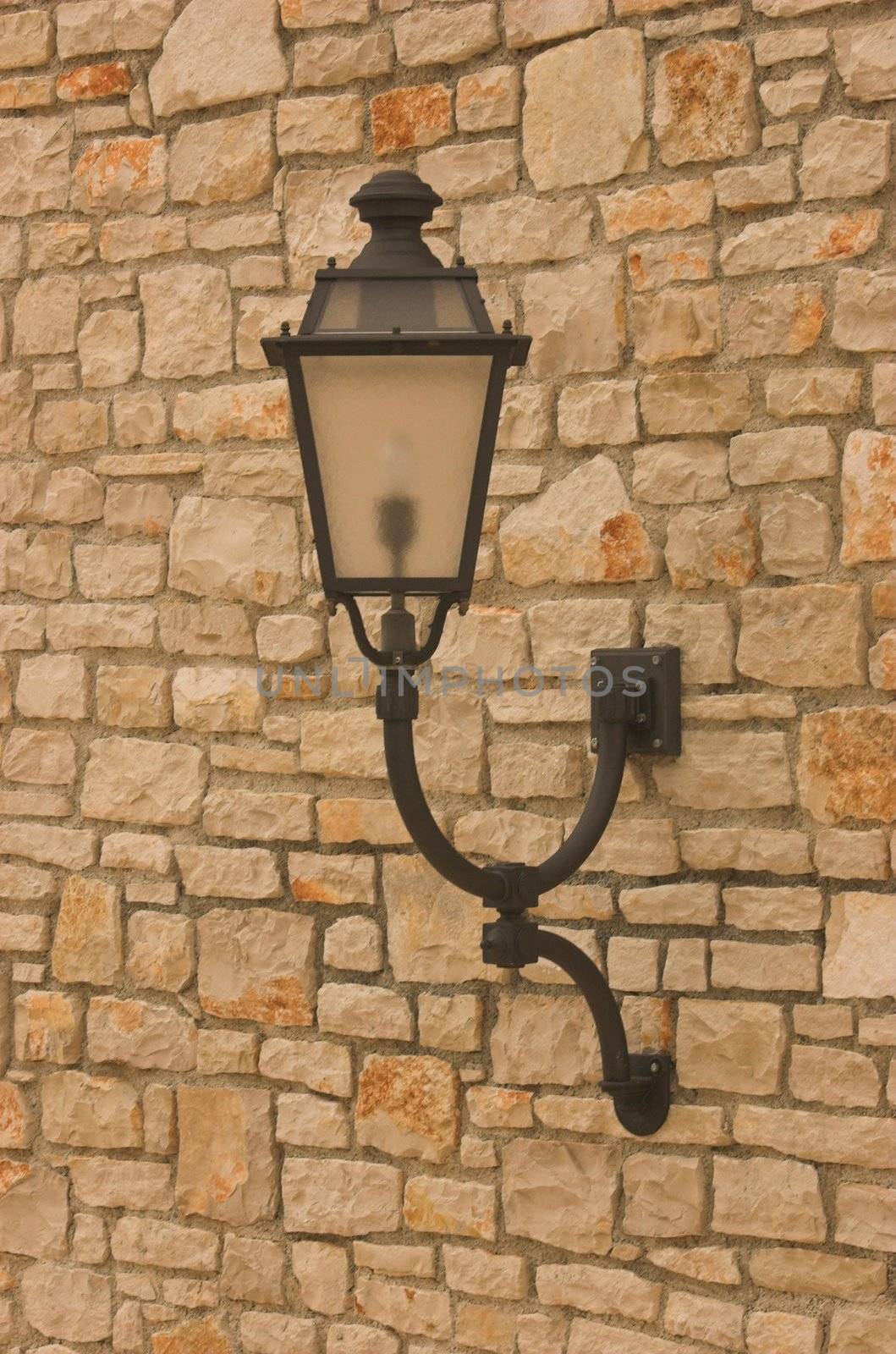 Electric lantern in old style hanging on a wall