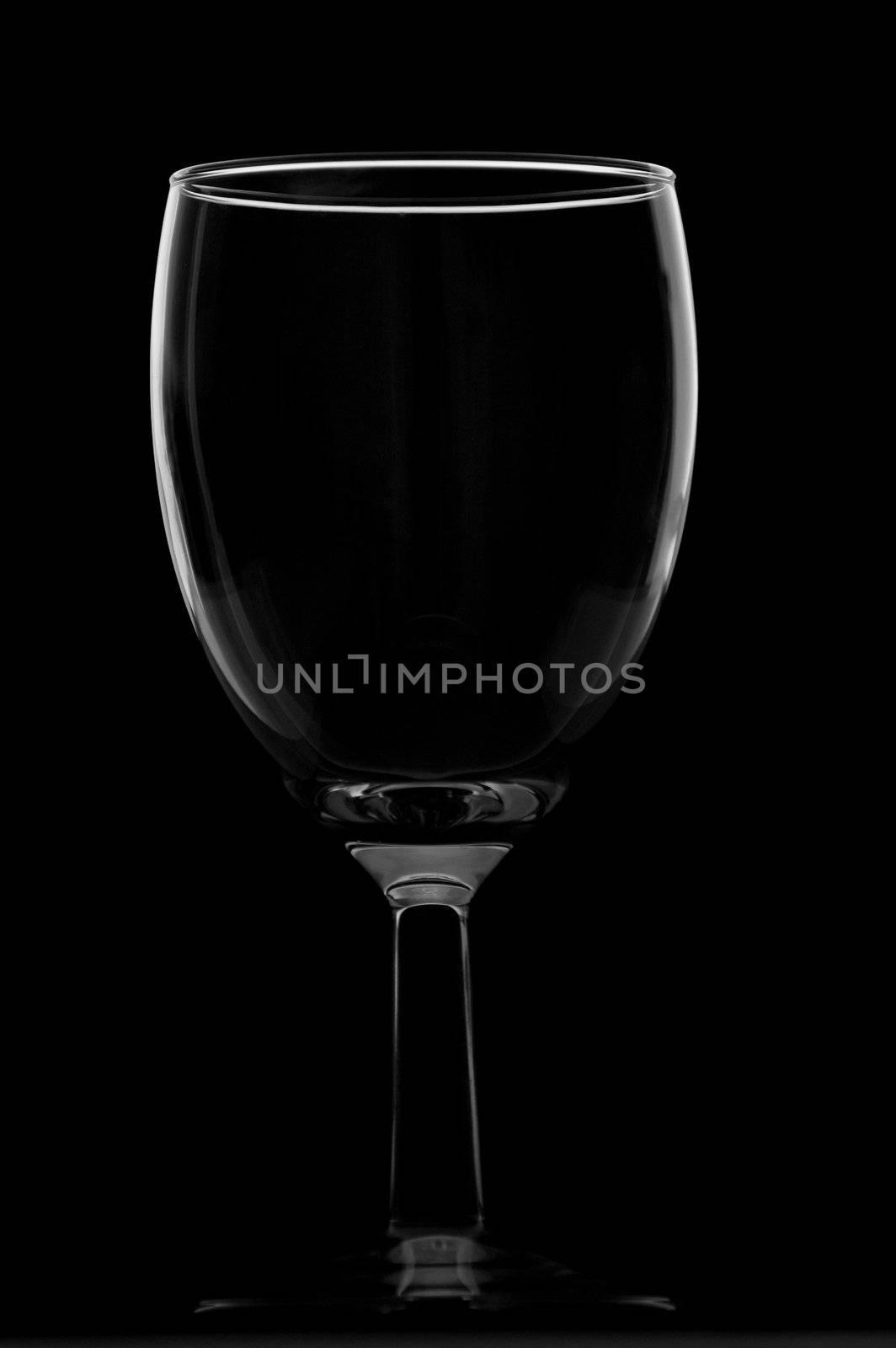 Short empty wine glass isolated on black