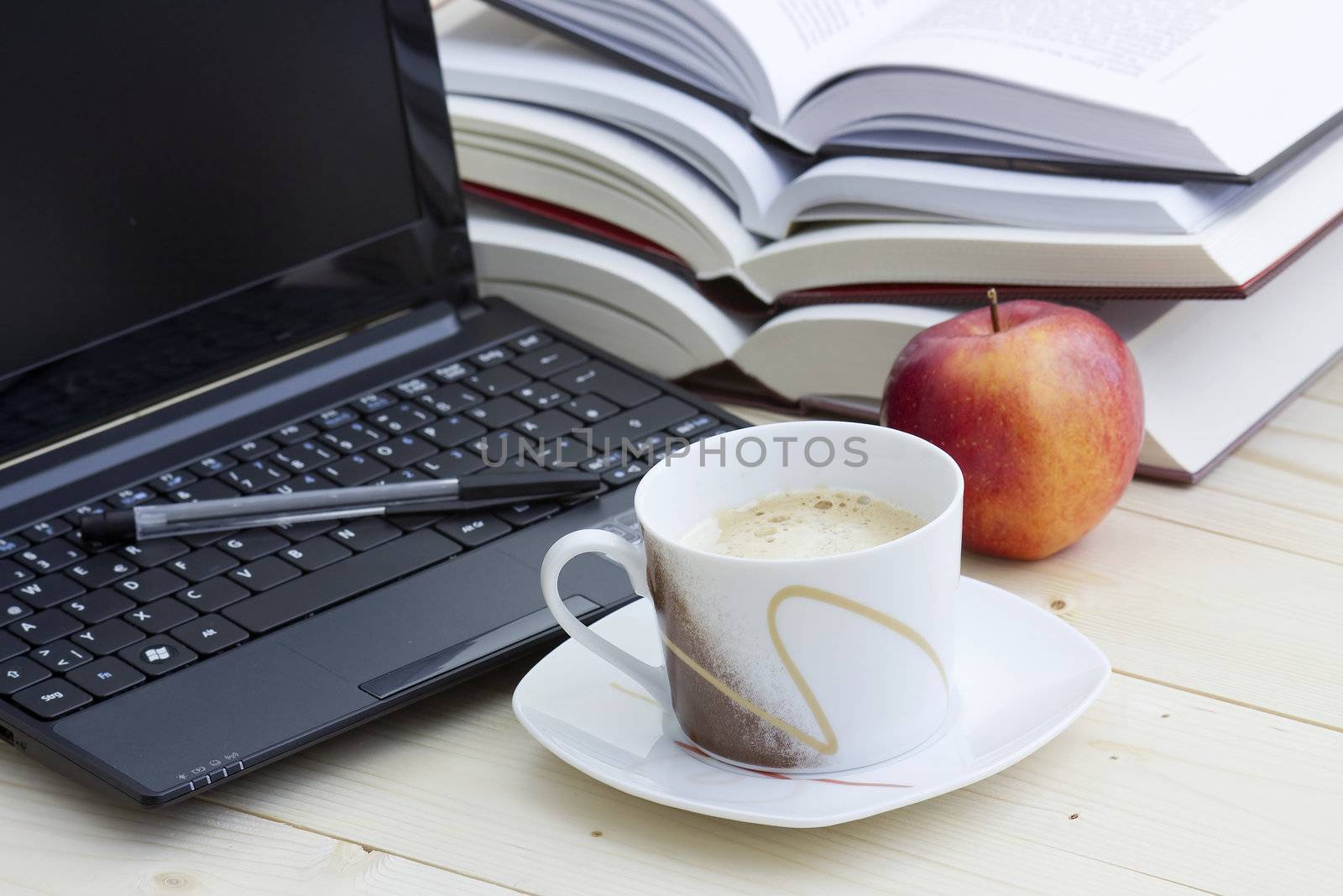 cup of coffee, laptop and books